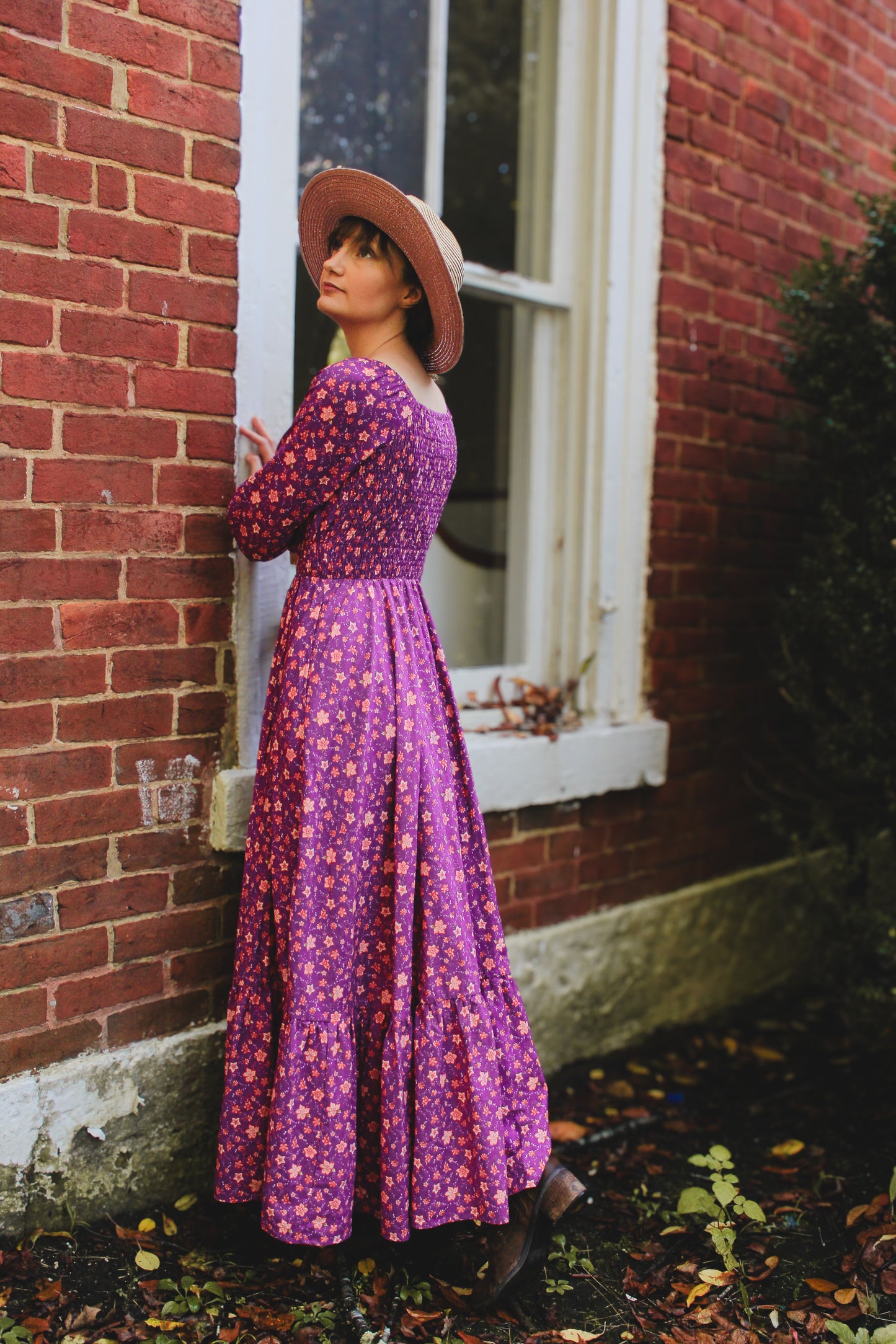 Woman in modest purple nursing dress outdoors