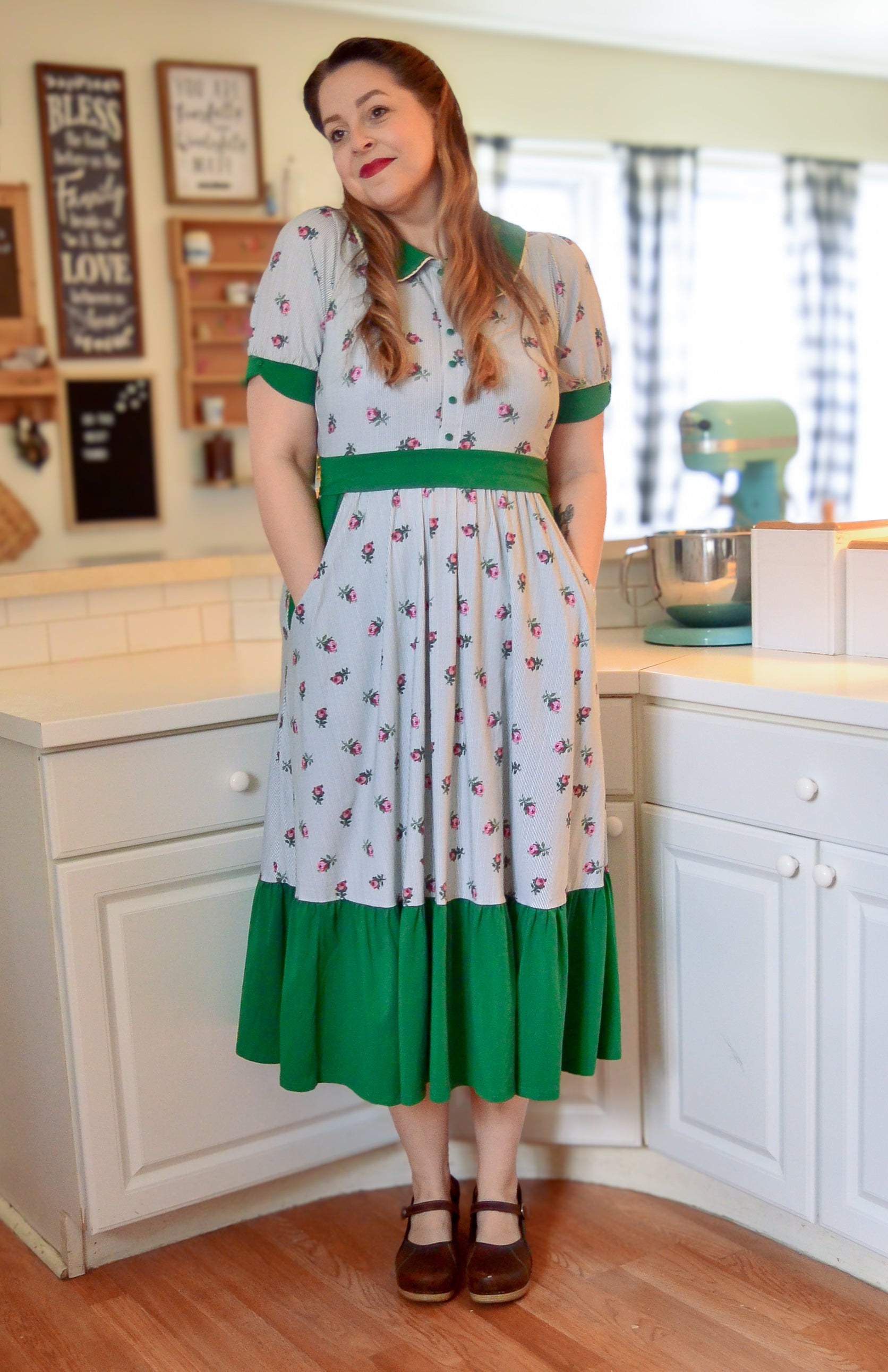 woman wearing a green and white striped modest nursing dress