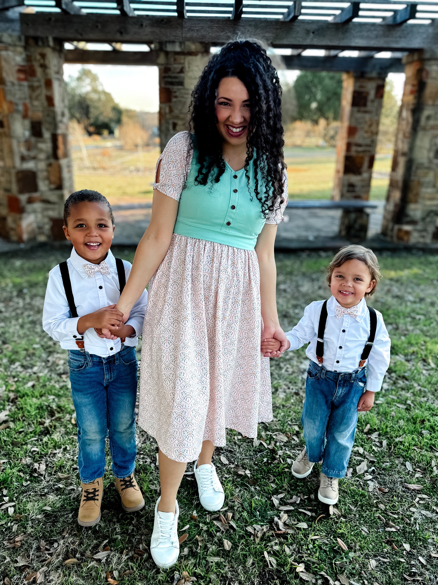 A woman wearing a vintage style modest nursing dress with her children.