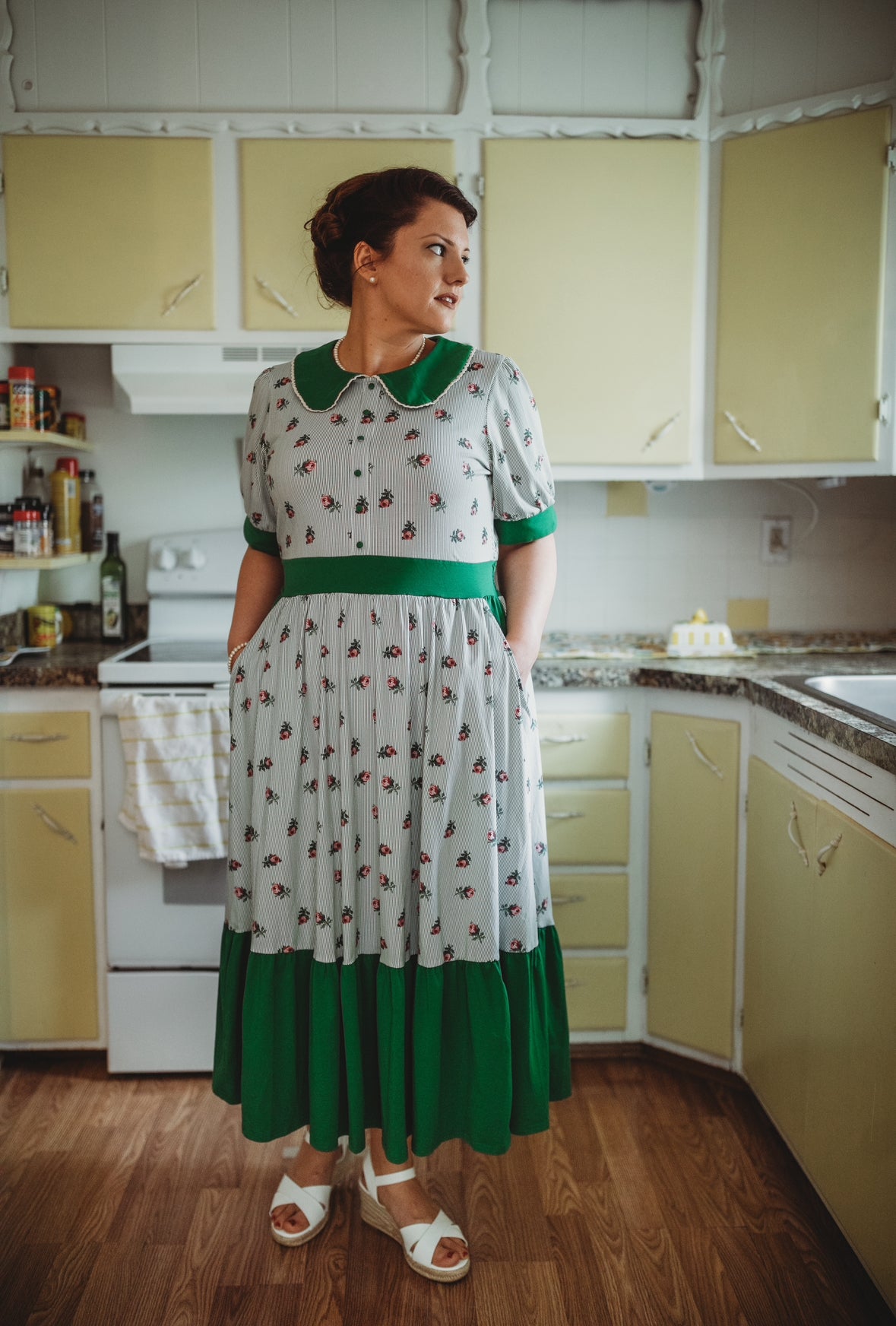 woman wearing a green and white striped modest nursing dress