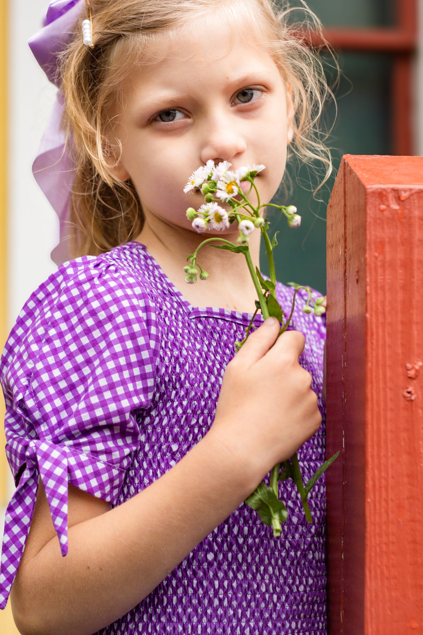 Young girl wearing a modest purple dress