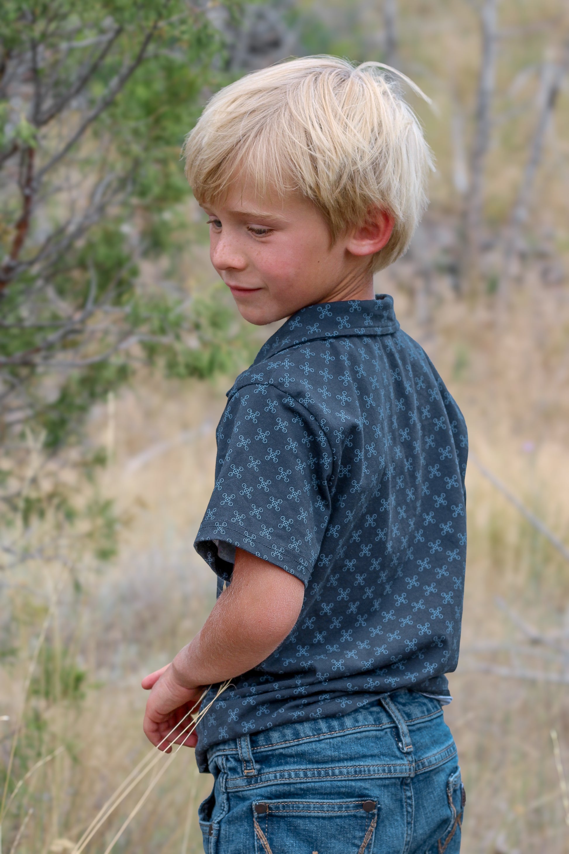 Young boy wearing a dark blue polo shirt