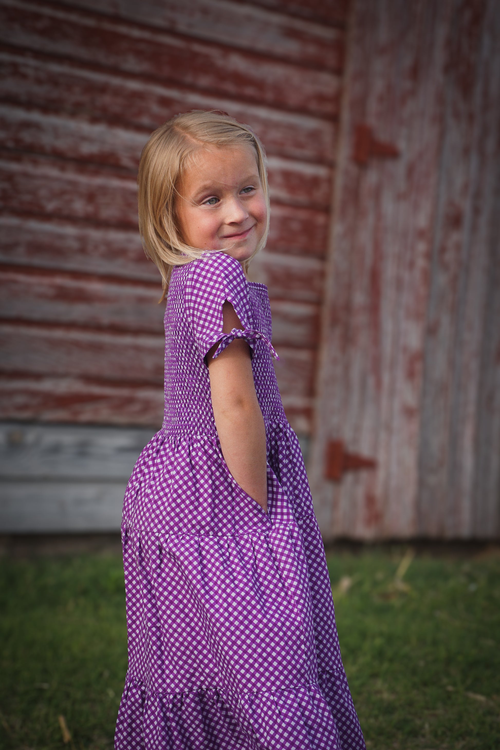 Young girl wearing a modest purple dress