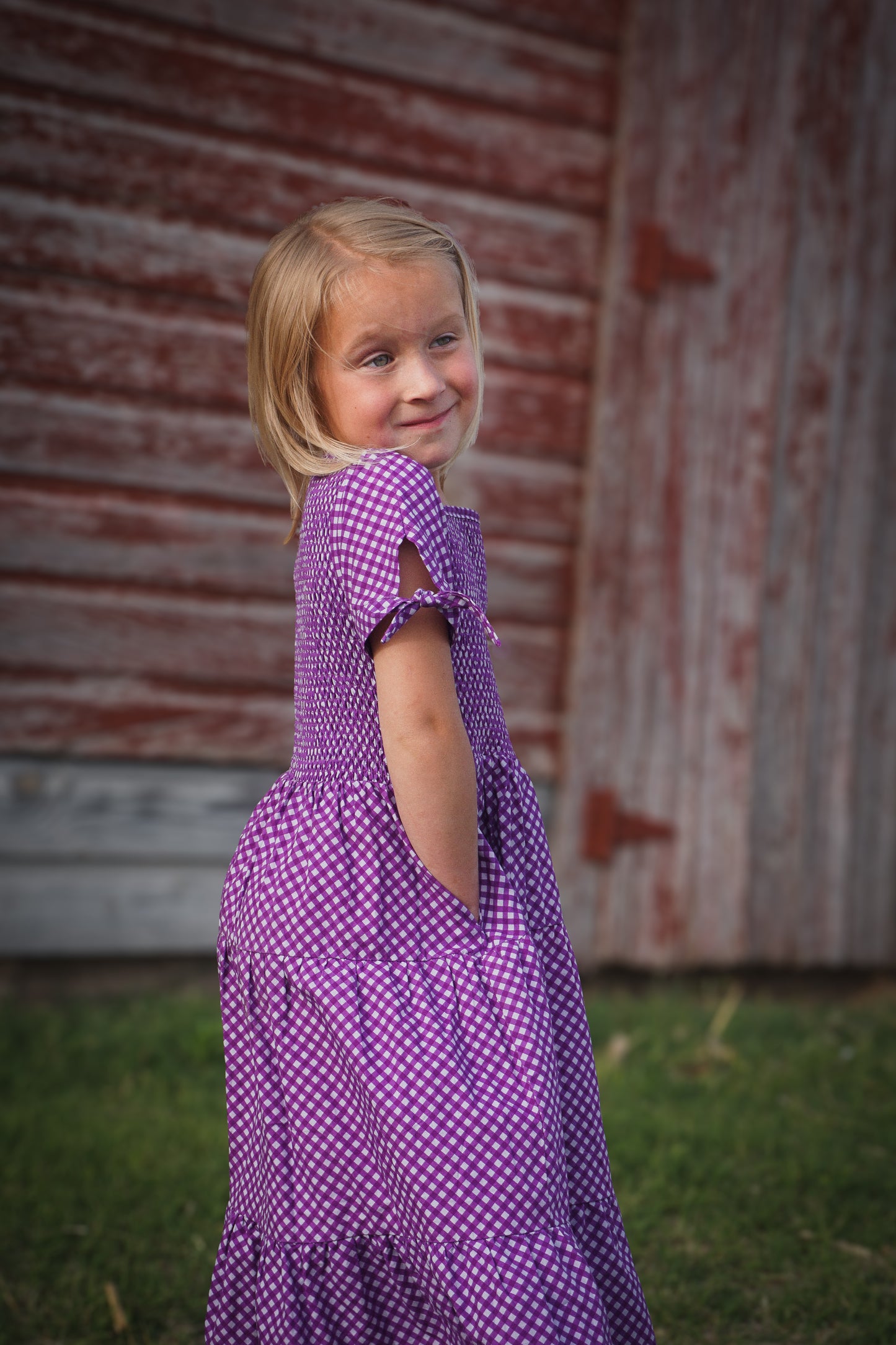 Young girl wearing a modest purple dress