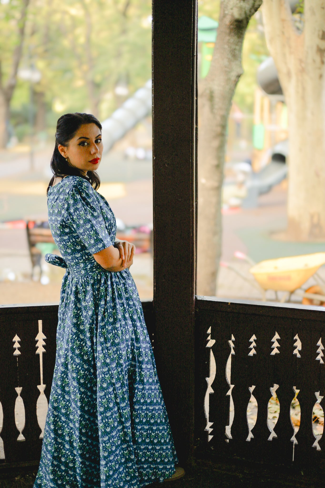 Woman in modest nursing dress by window