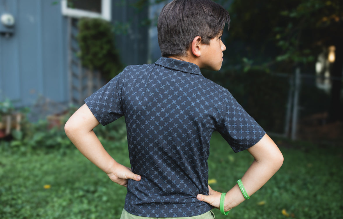 Young boy wearing a dark blue polo shirt