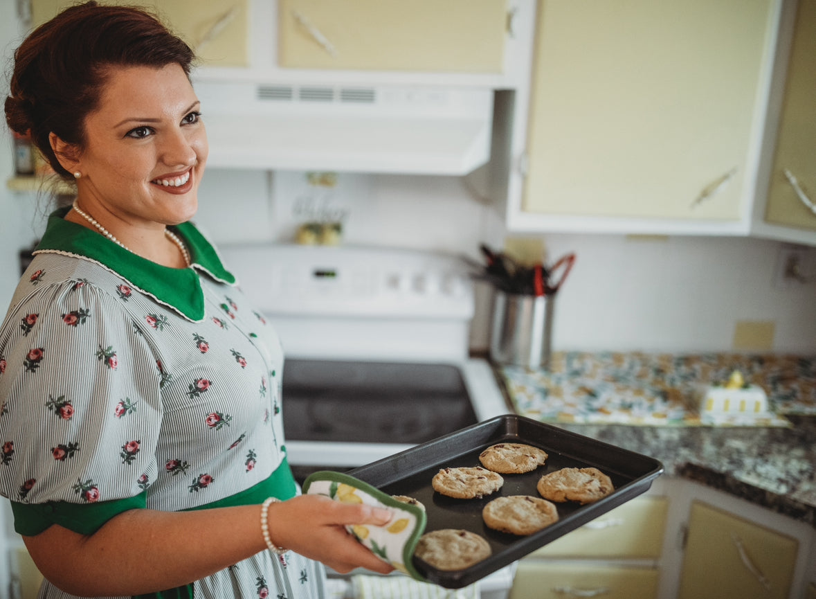 woman wearing a green and white striped modest nursing dress