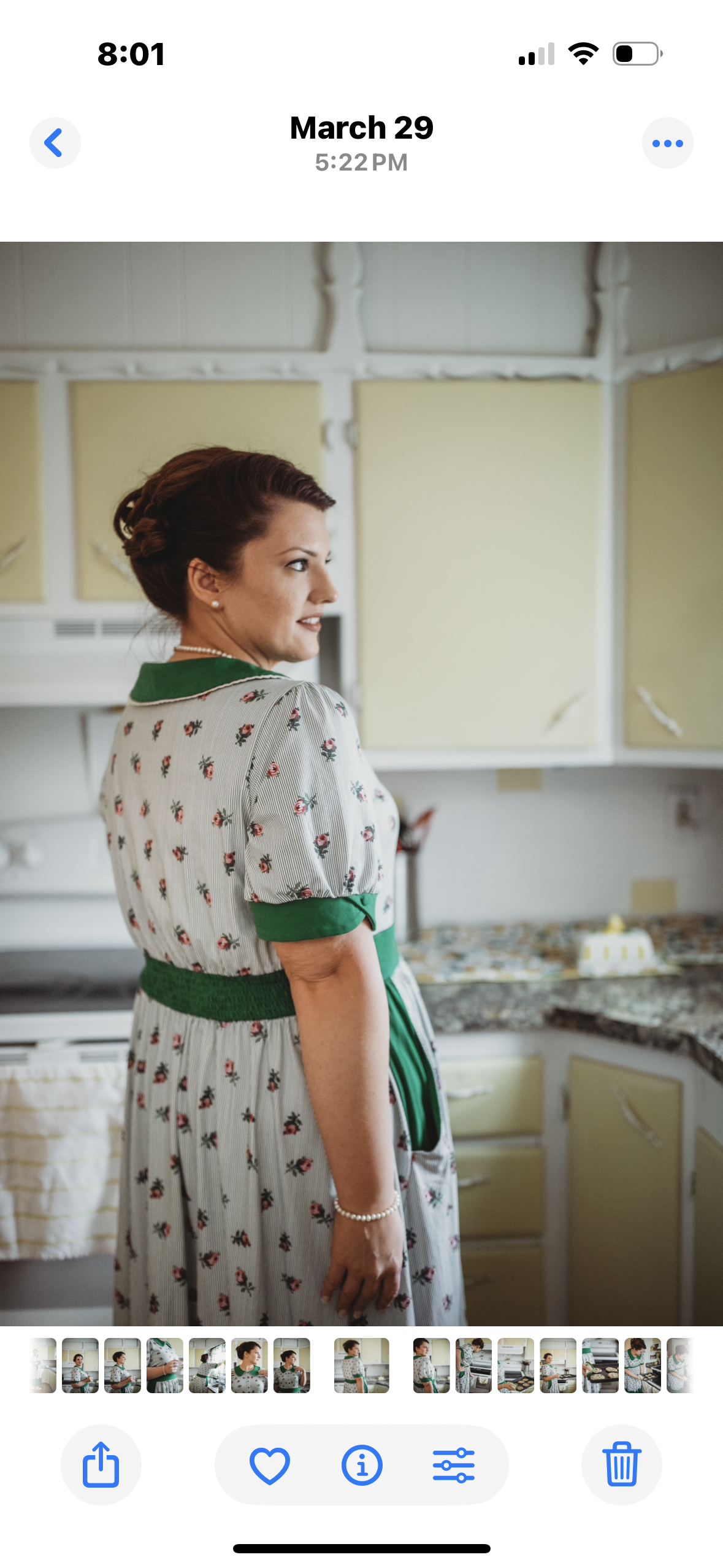 woman wearing a green and white striped modest nursing dress