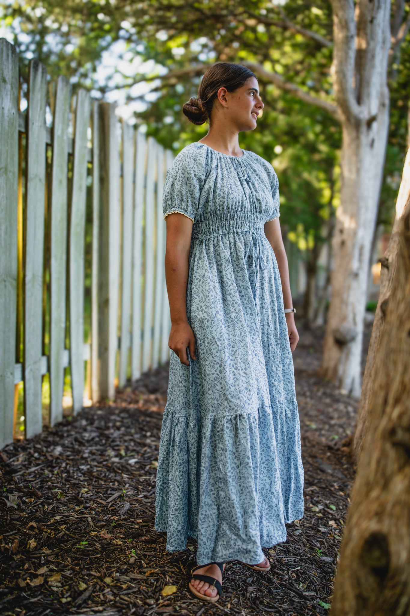 woman in a modest blue nursing dress