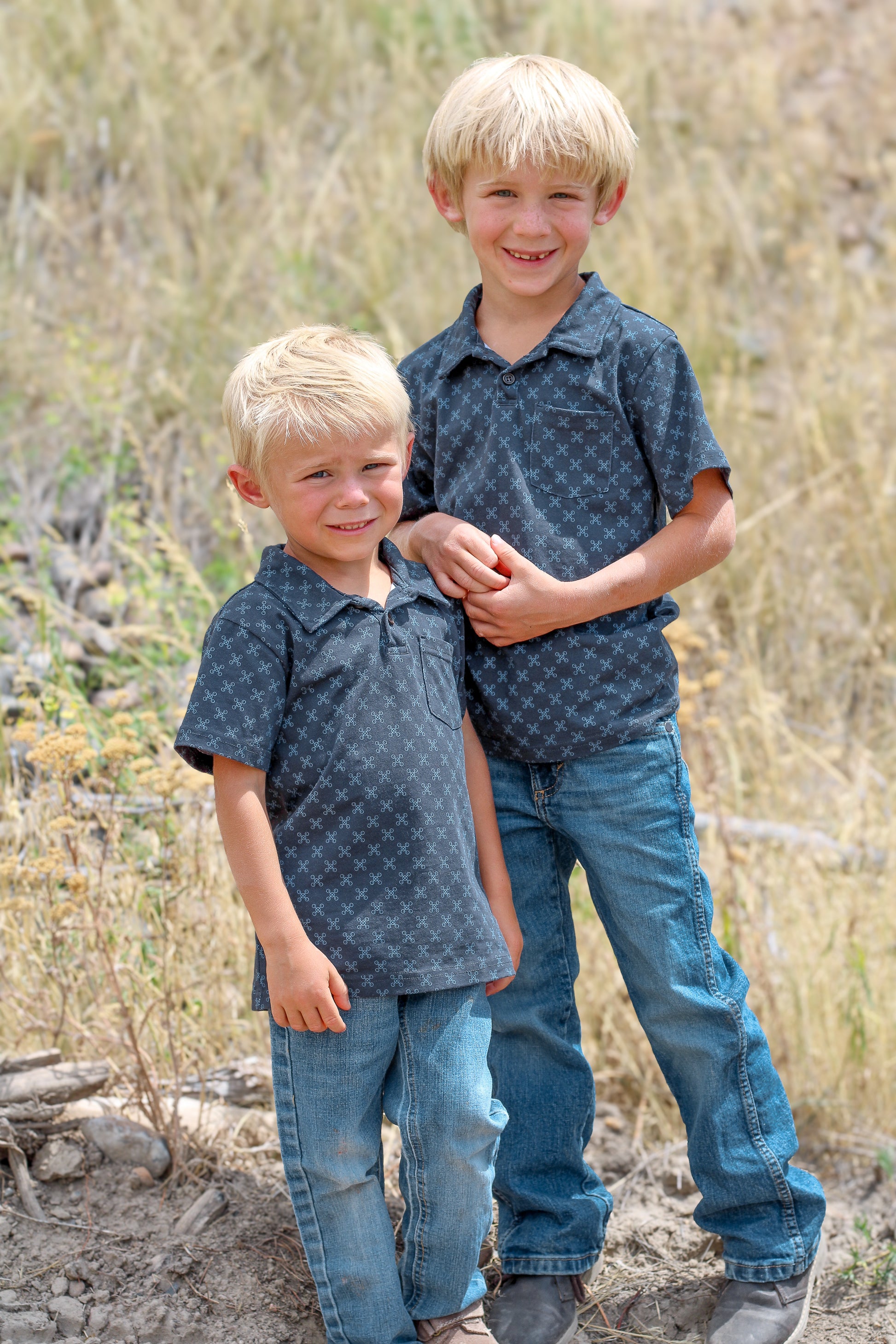 Young boys wearing dark blue polo shirts