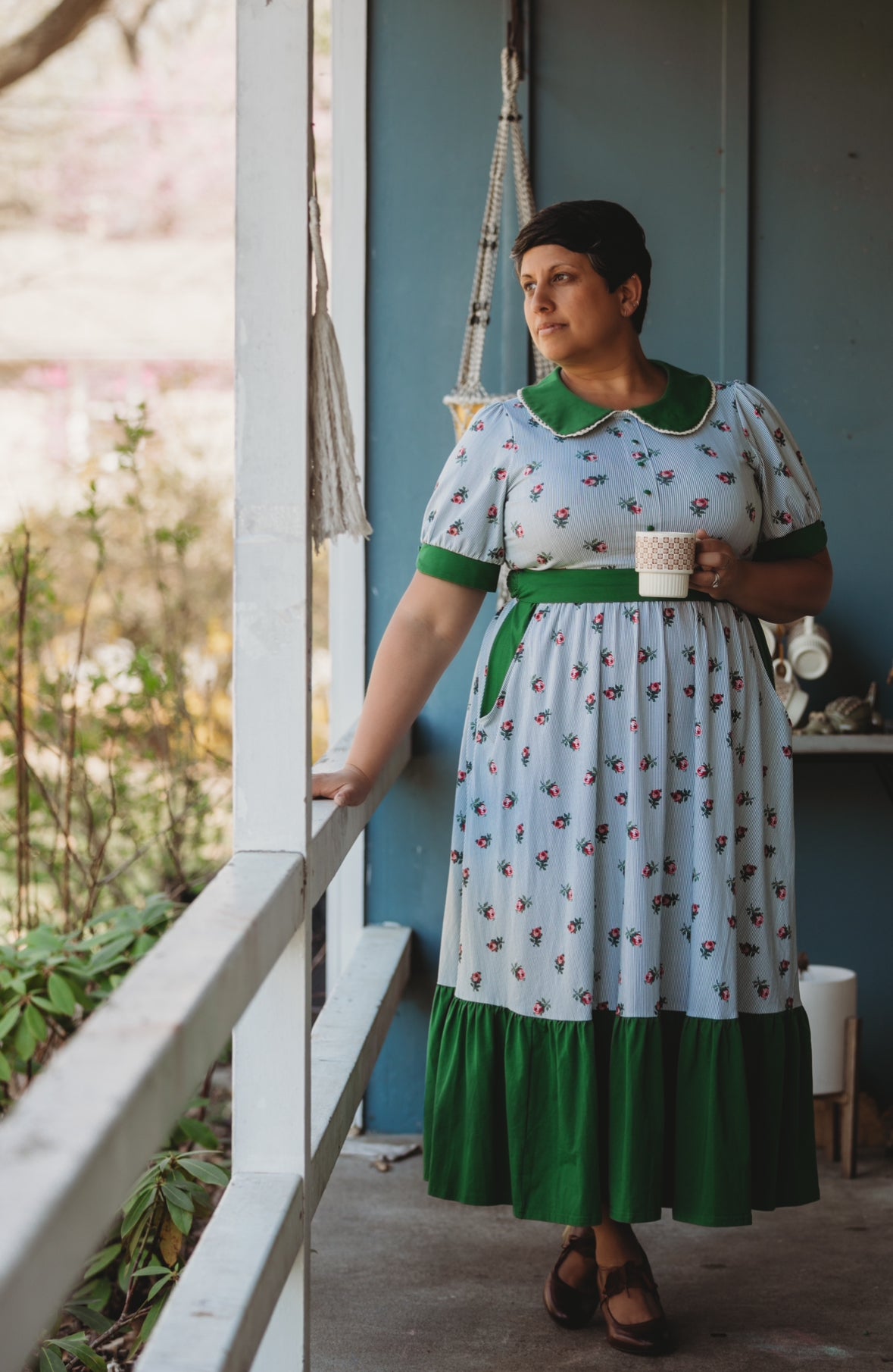 woman wearing a green and white striped modest nursing dress
