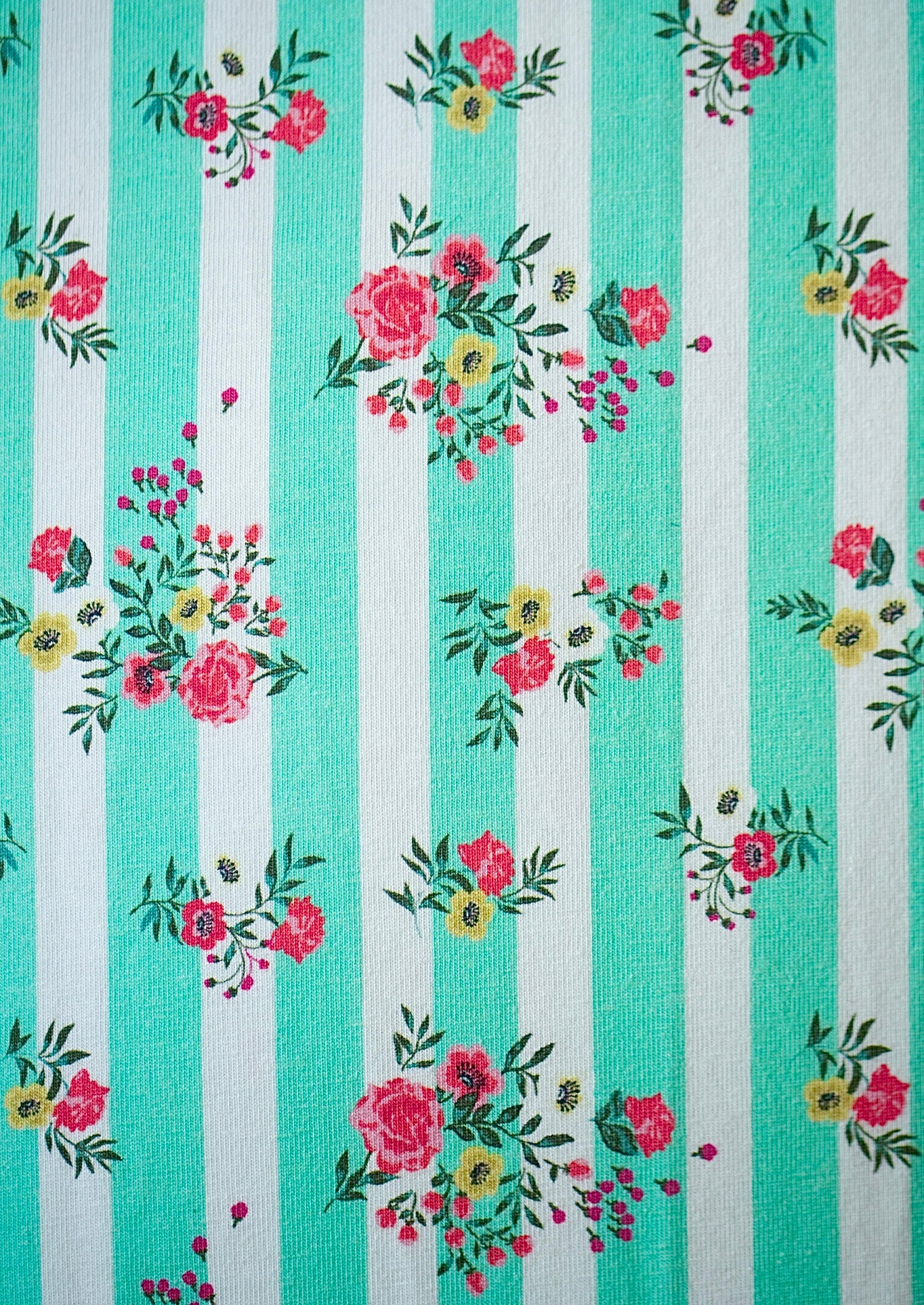 Teal and white striped pattern with floral designs