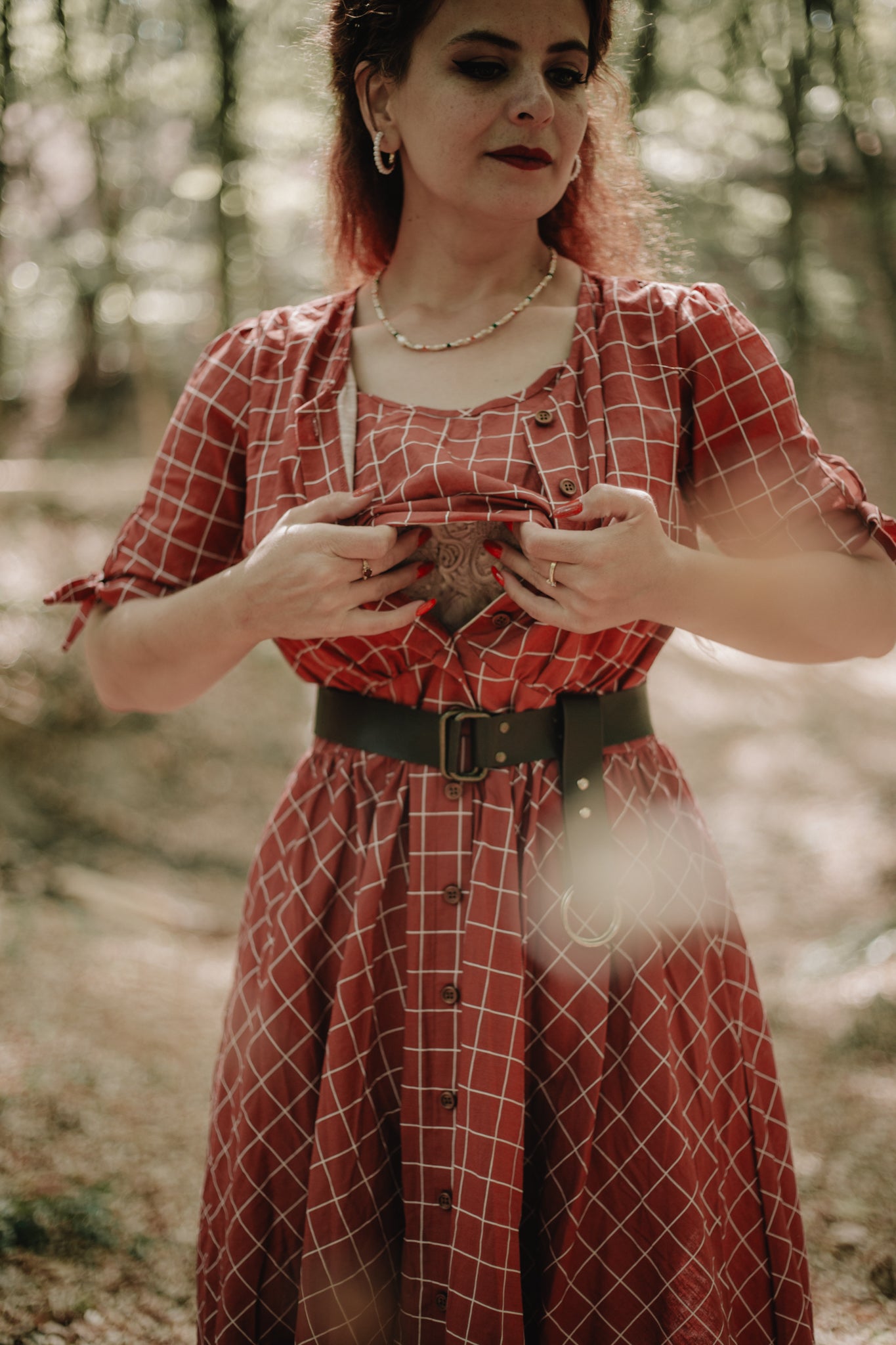 Woman in modest nursing red checkered dress phone