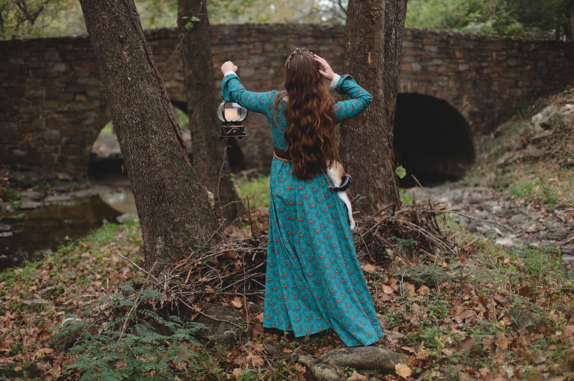 Woman in modest nursing blue dress in forest