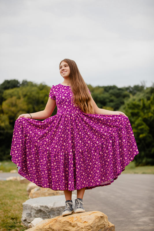 Woman in modest nursing-friendly purple floral dress outdoors