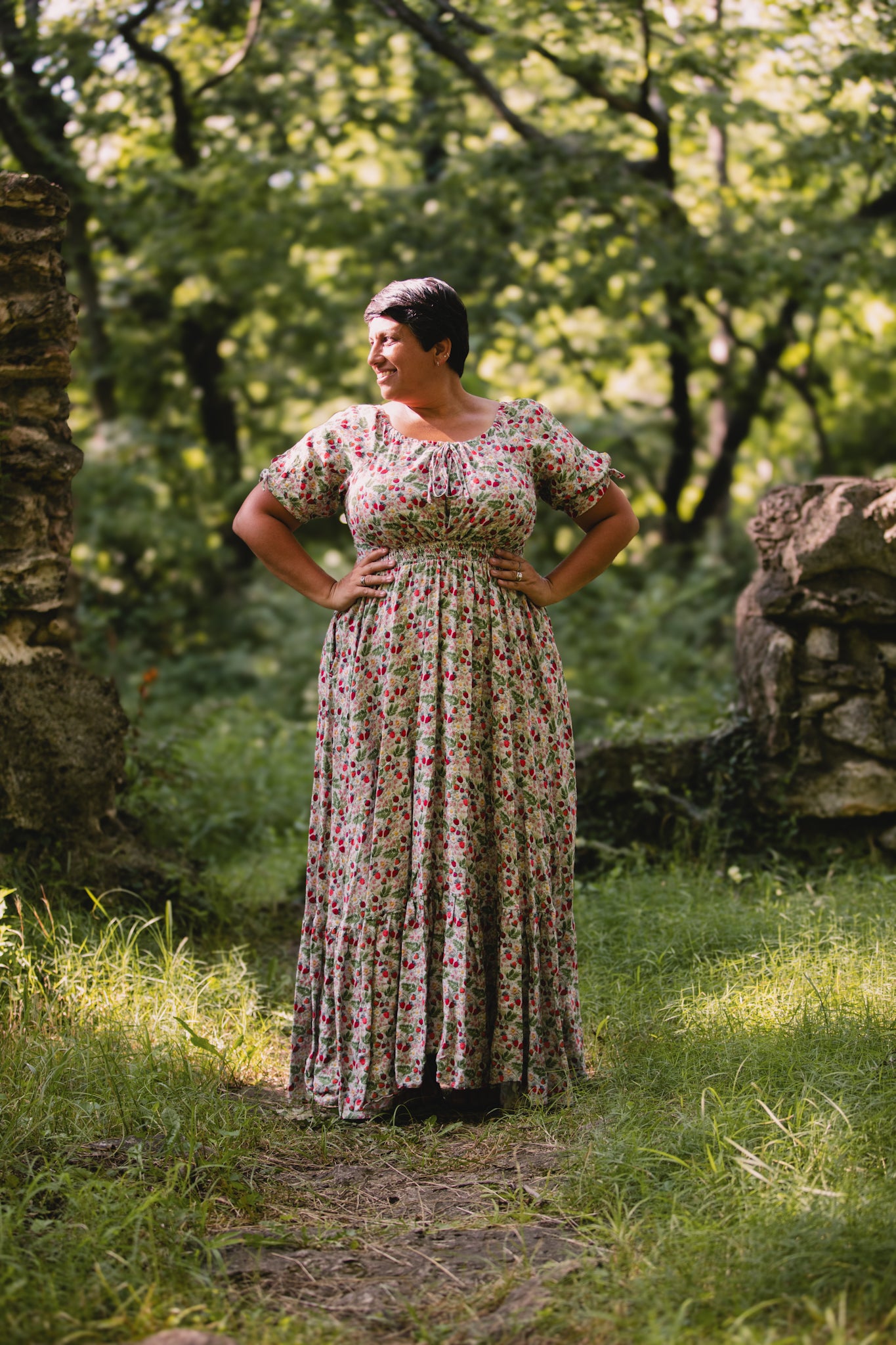 Woman in a floral modest nursing dress standing in a forest