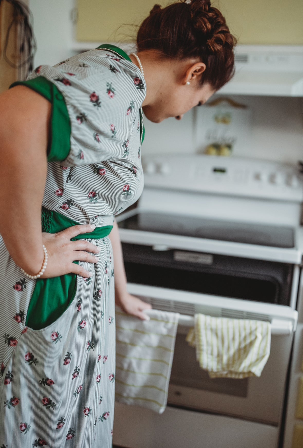woman wearing a green and white striped modest nursing dress