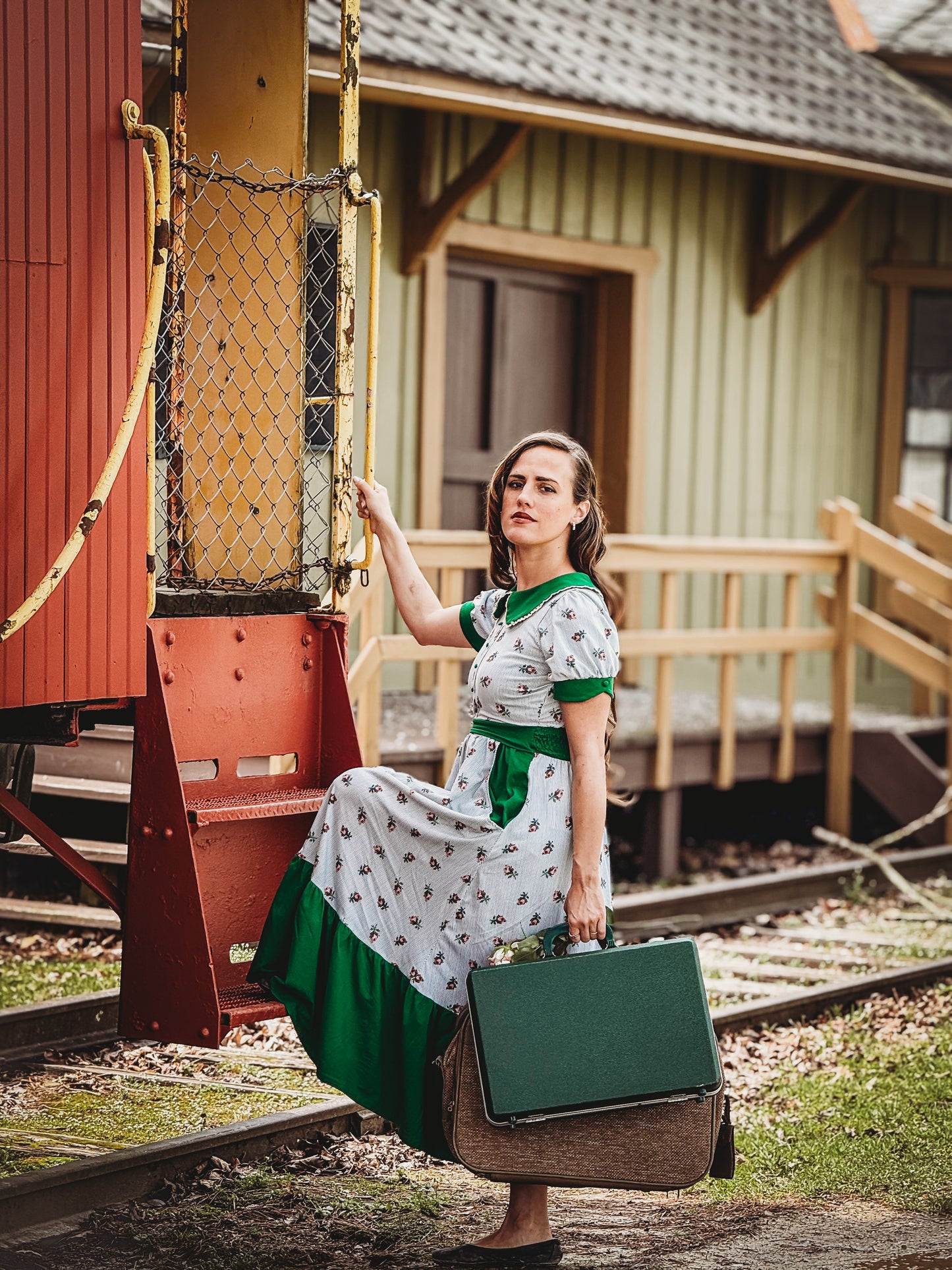 woman wearing a green and white striped modest nursing dress