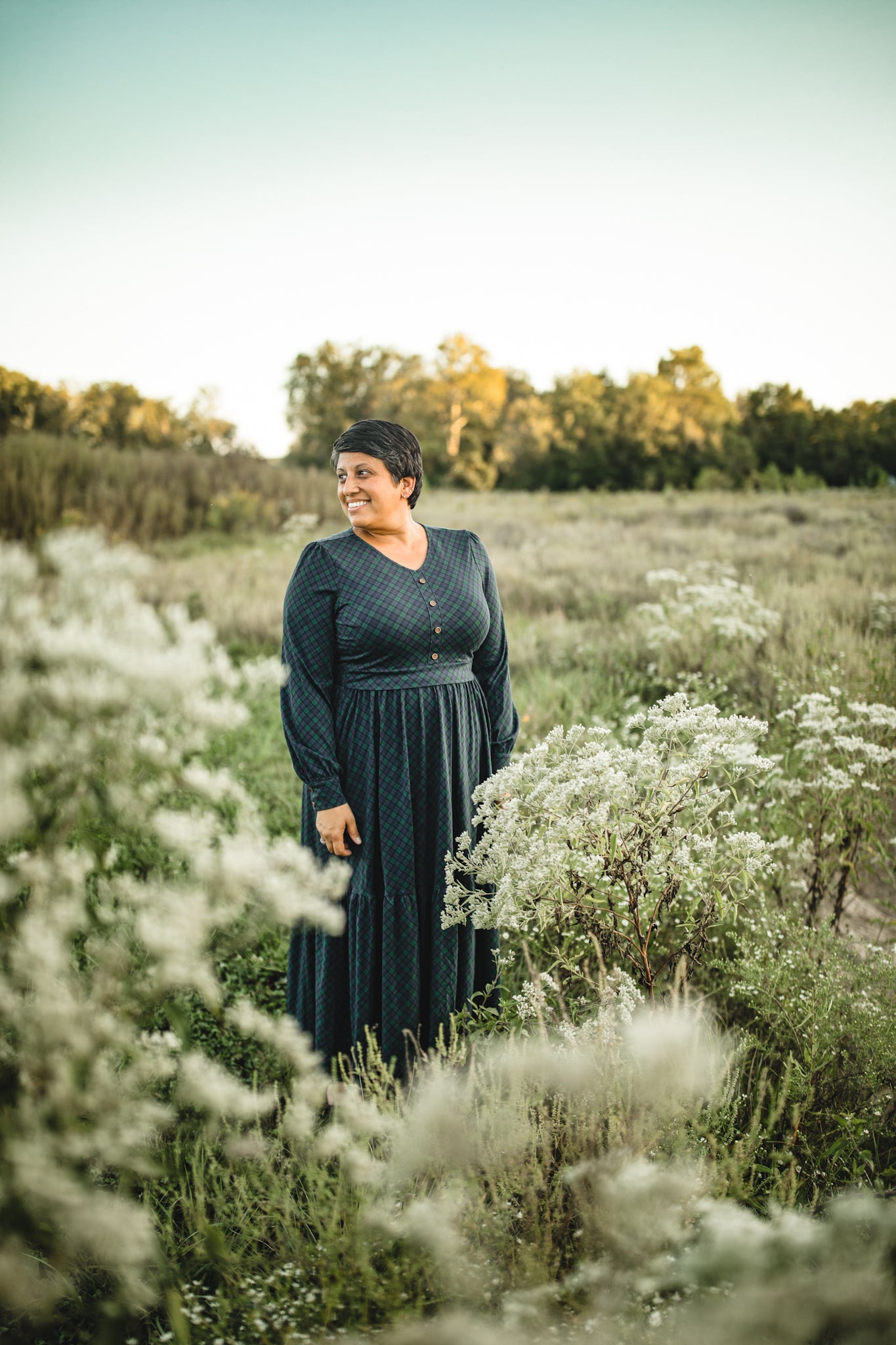Woman in modest nursing dress white flowers outdoors