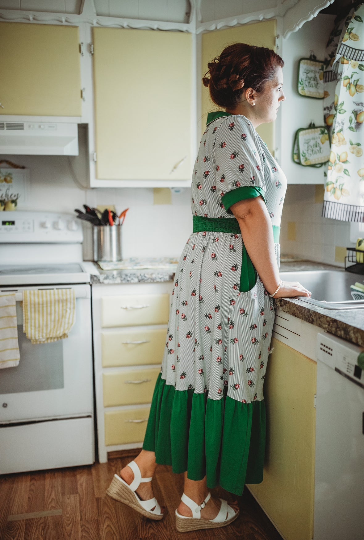 woman wearing a green and white striped modest nursing dress