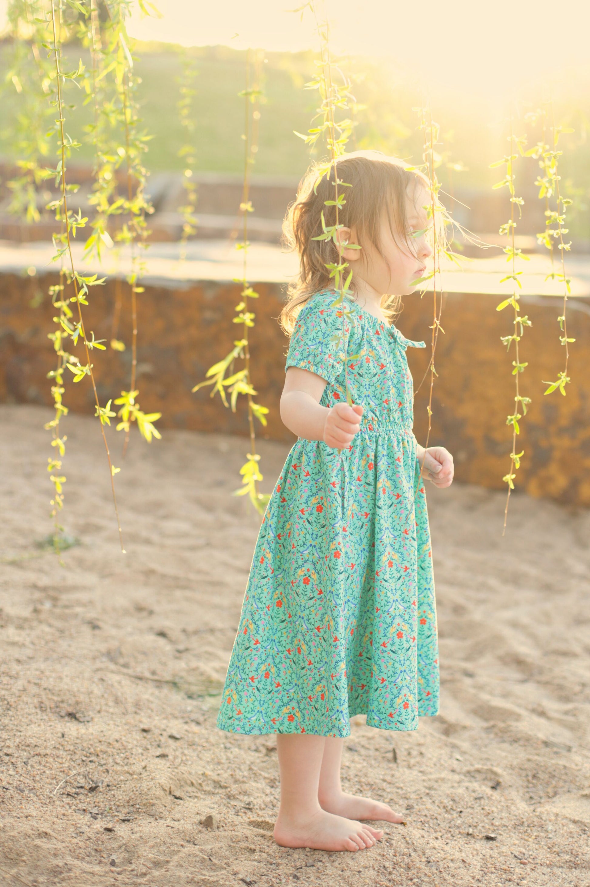 Young girl wearing a modest green dress