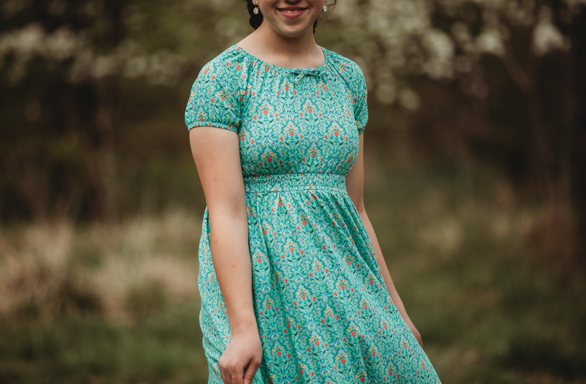 Young girl wearing a modest green dress