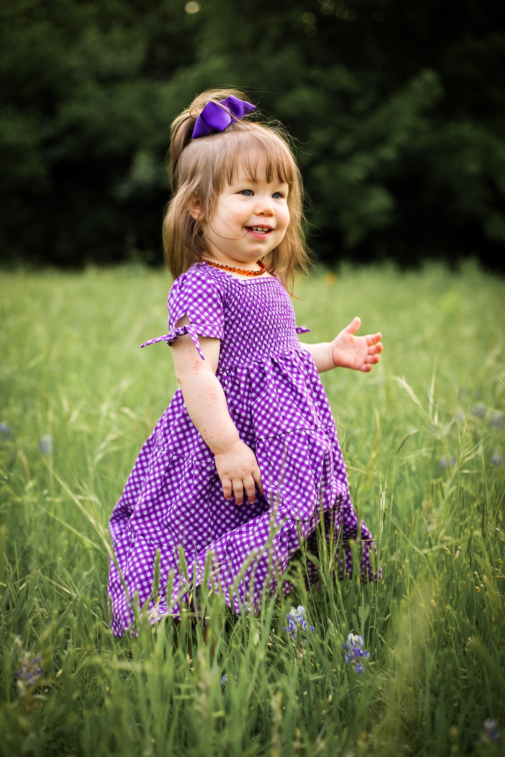 Young girl wearing a modest purple dress