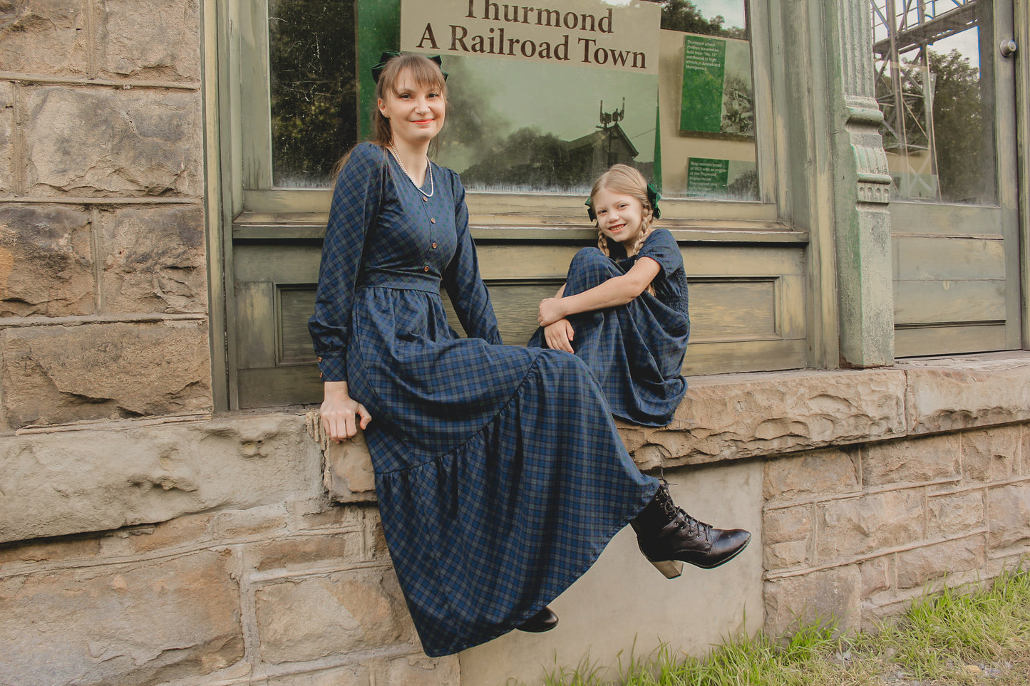 Two women in modest nursing blue dresses outdoors together