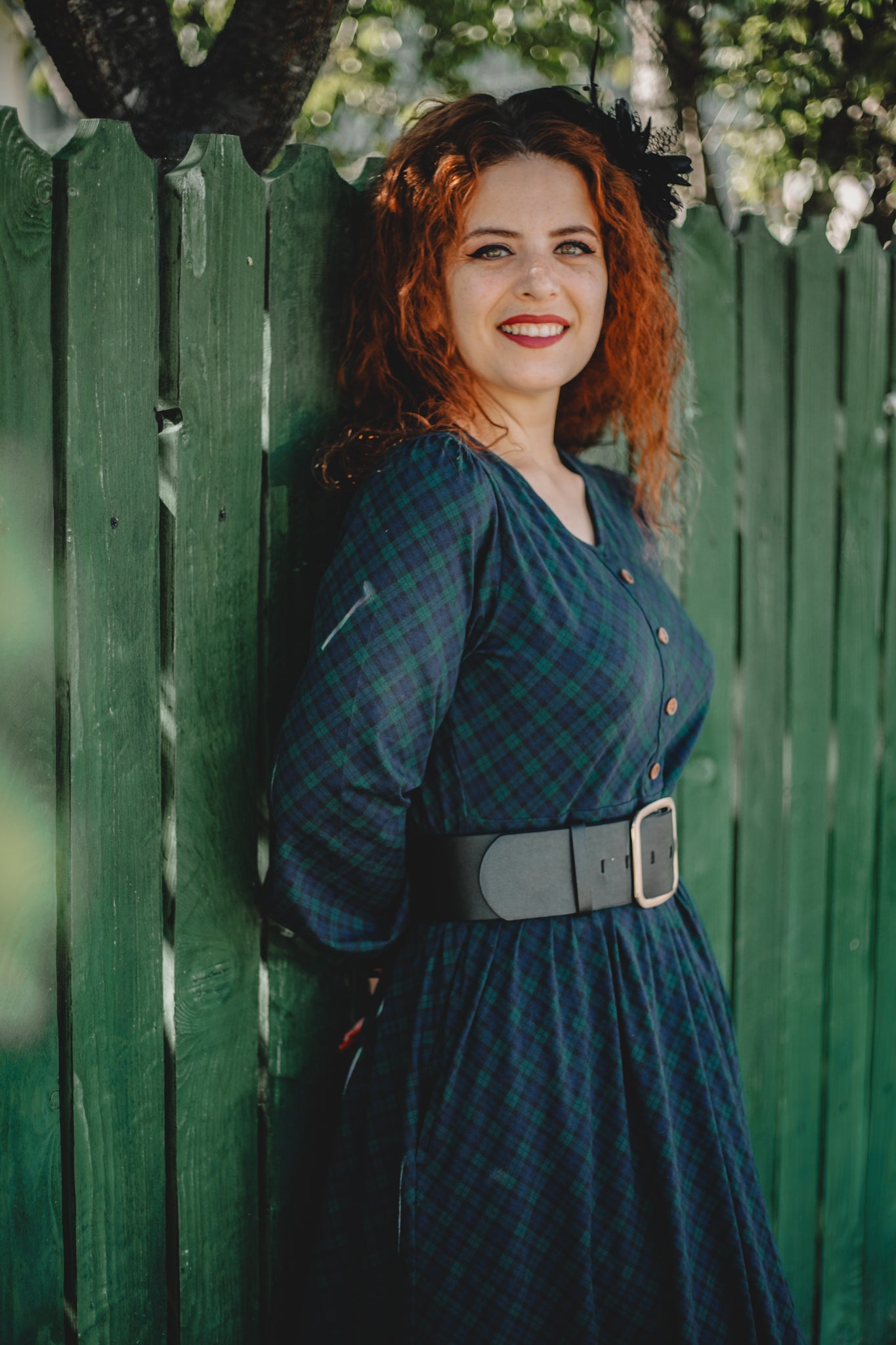 Woman in modest nursing blue plaid dress outdoors