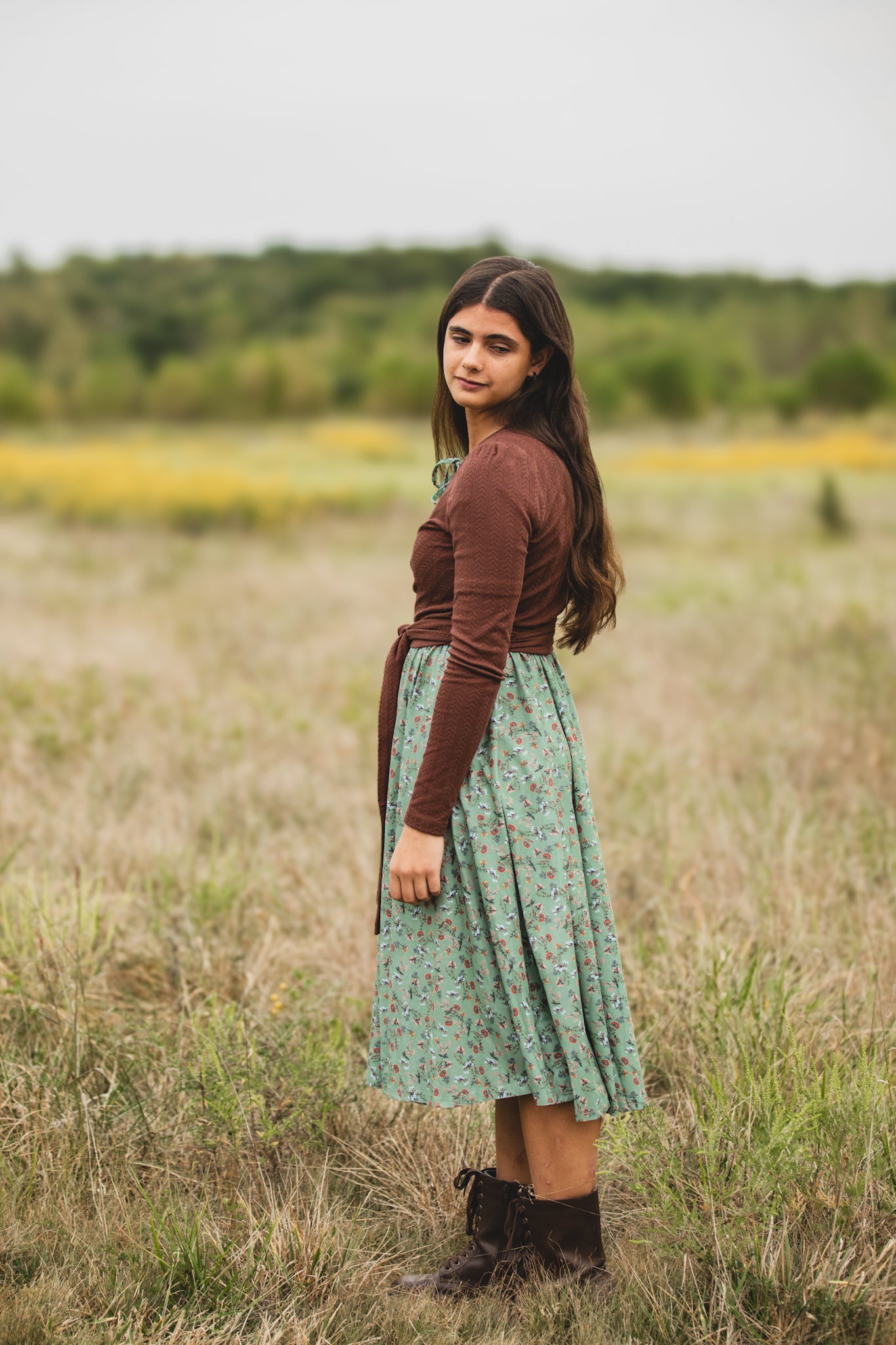 Woman in modest nursing dress in field