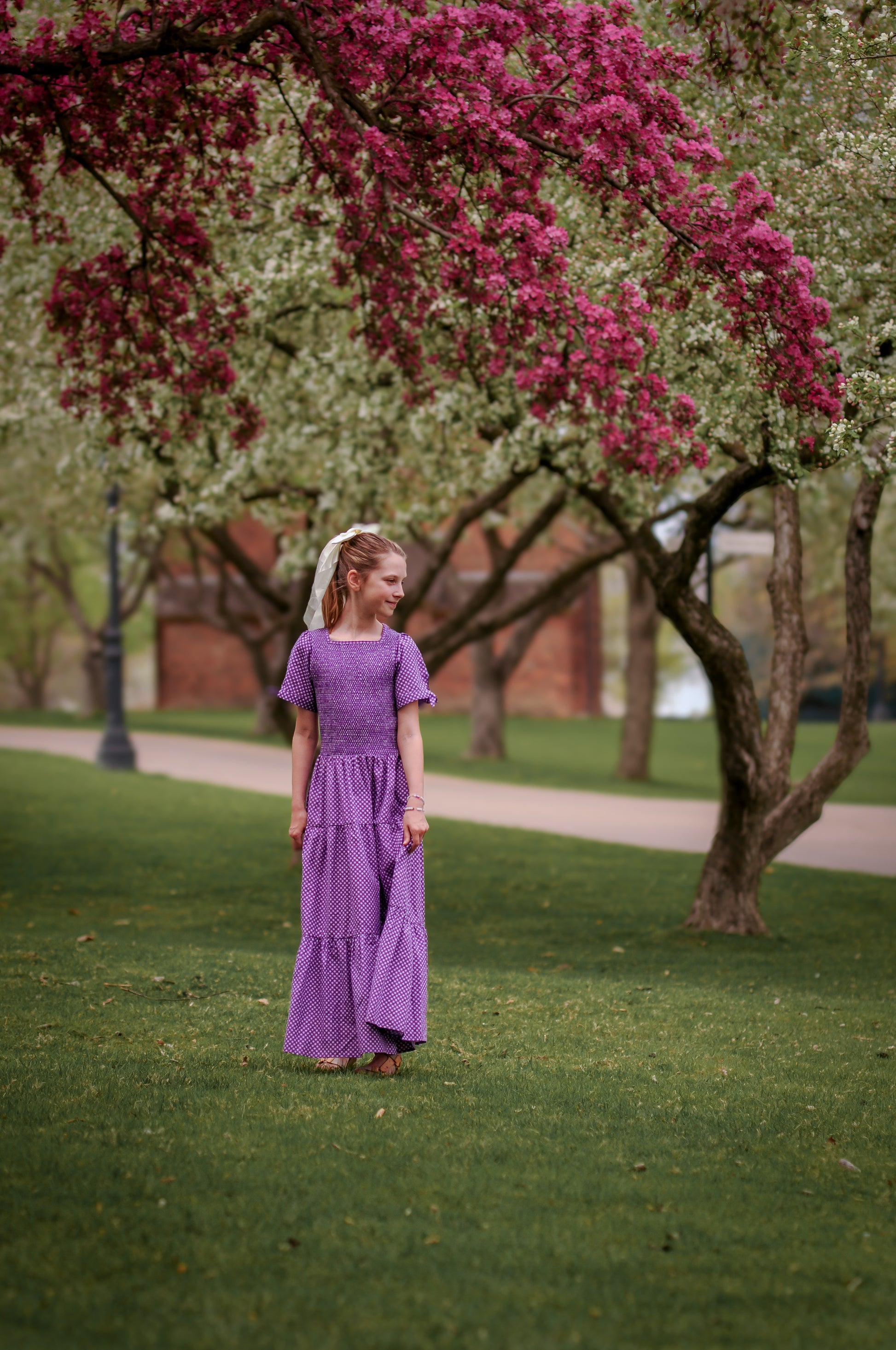Young girl wearing a modest purple dress