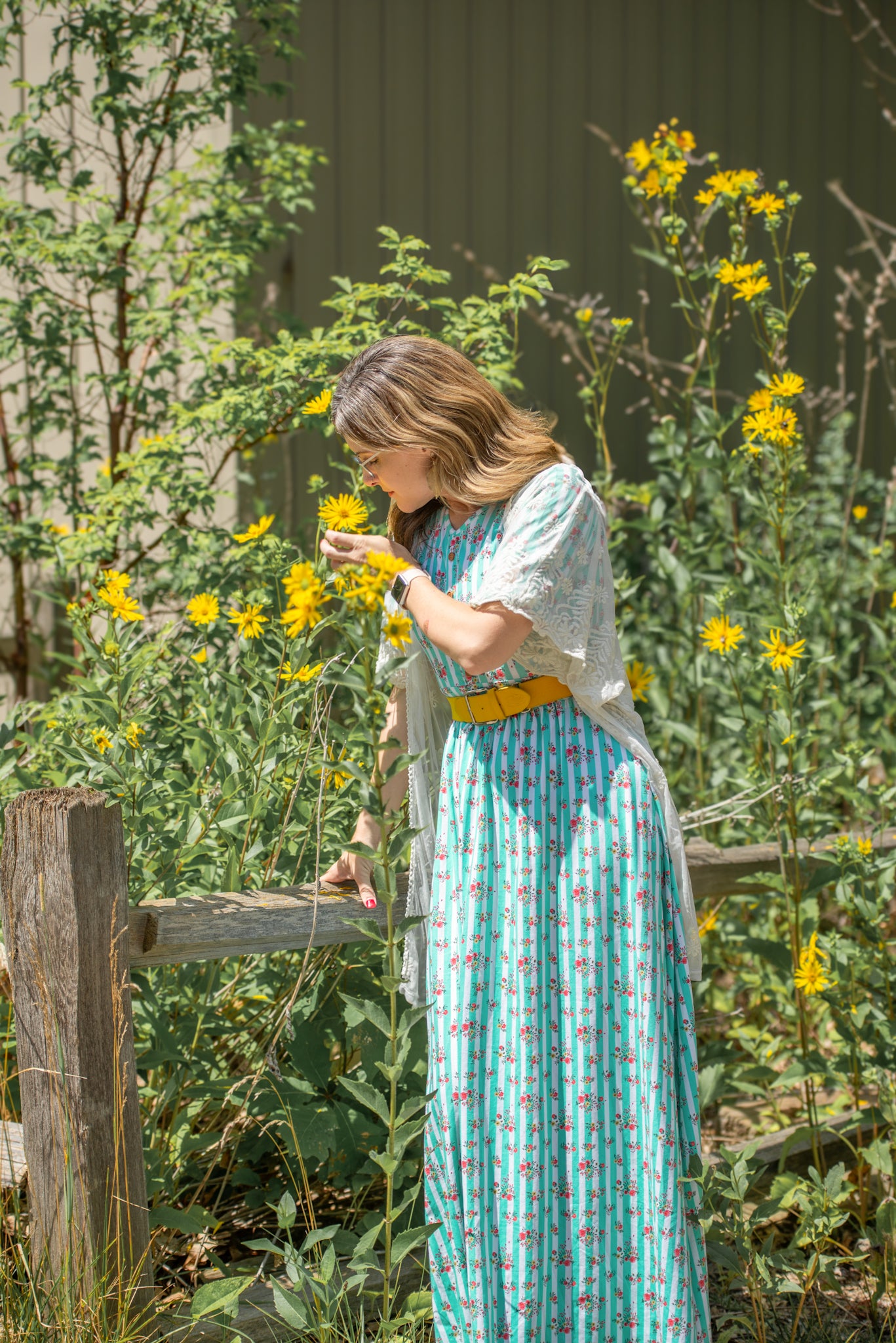 Woman in a garden with modest nursing dress