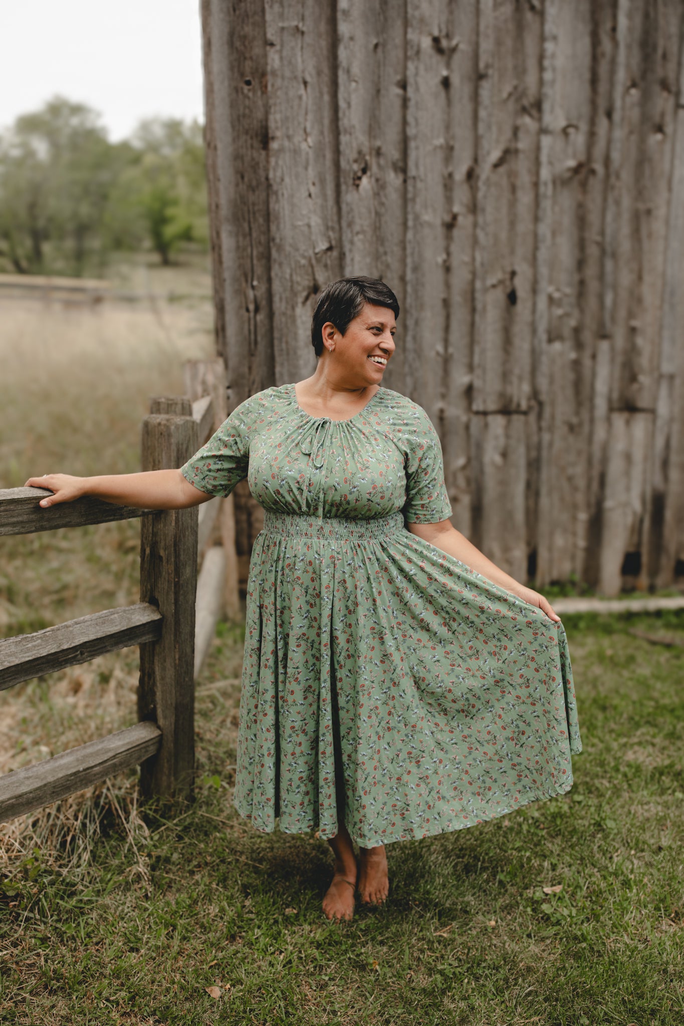 Woman in modest nursing dress by fence