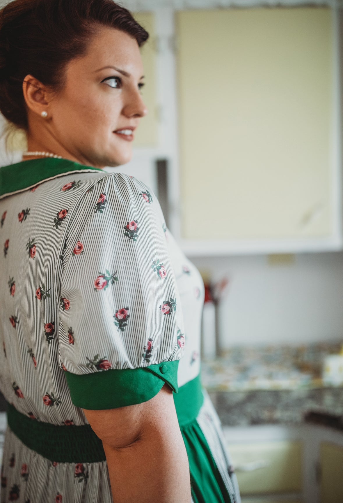 woman wearing a green and white striped modest nursing dress