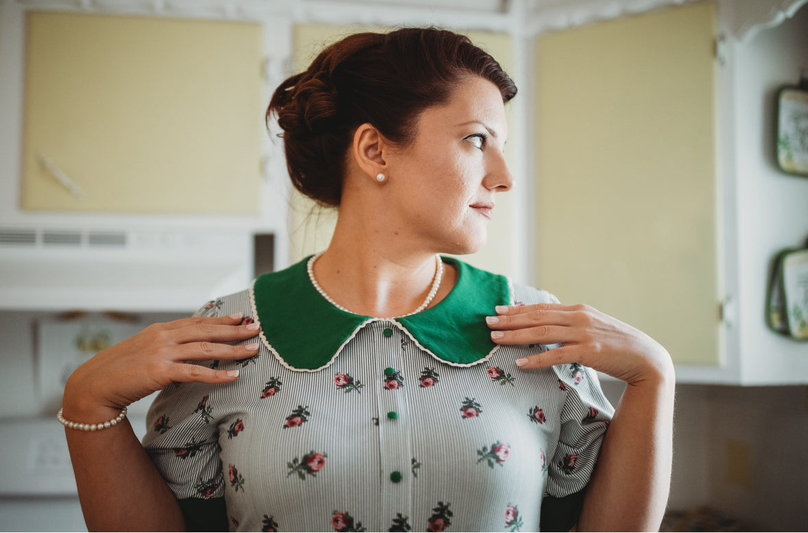 woman wearing a green and white striped modest nursing dress