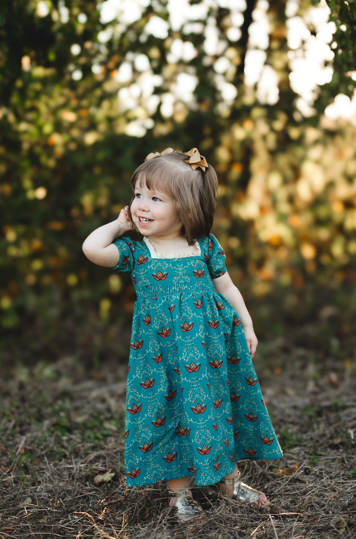 Young girl wearing modest dress with butterflies outdoors