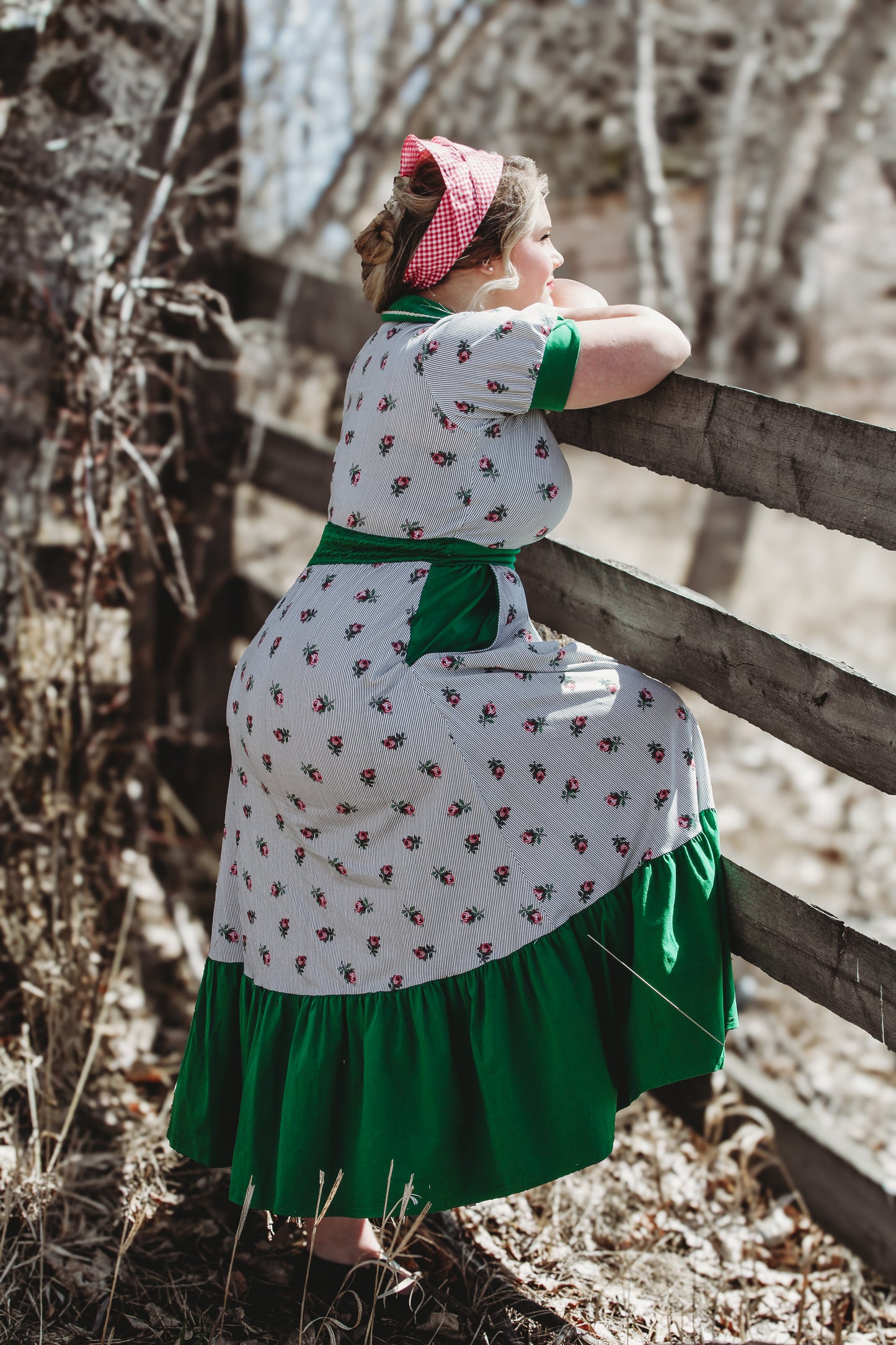 woman wearing a green and white striped modest nursing dress