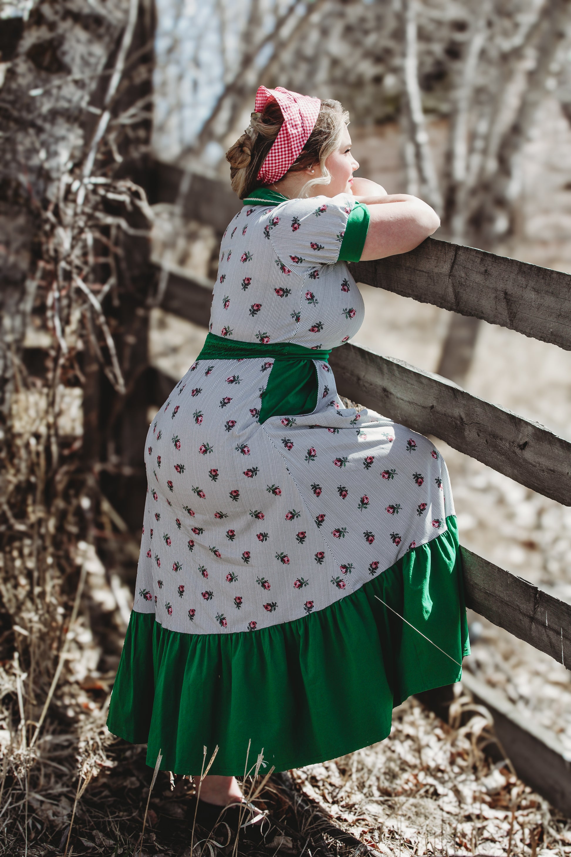 woman wearing a green and white striped modest nursing dress