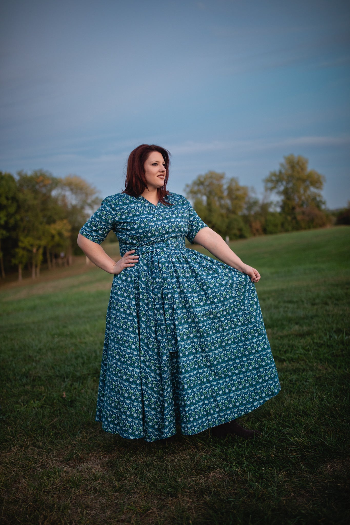 Woman in modest nursing dress in field