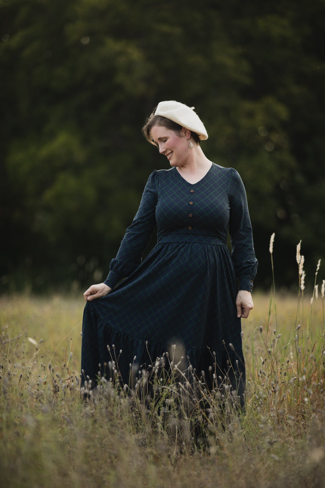 Woman in modest nursing dress with hat outdoors