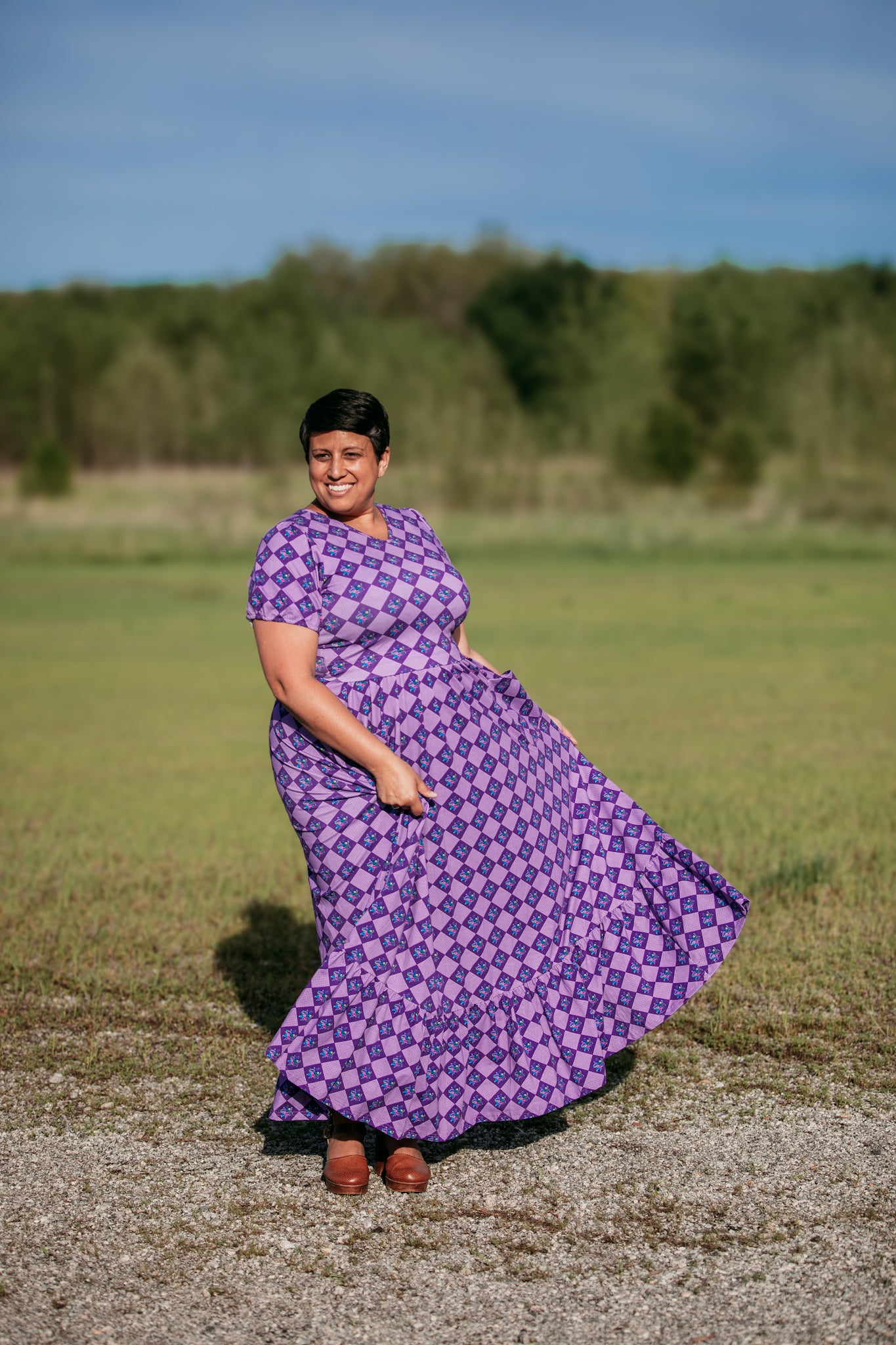 Woman in a purple checkered modest nursing dress.