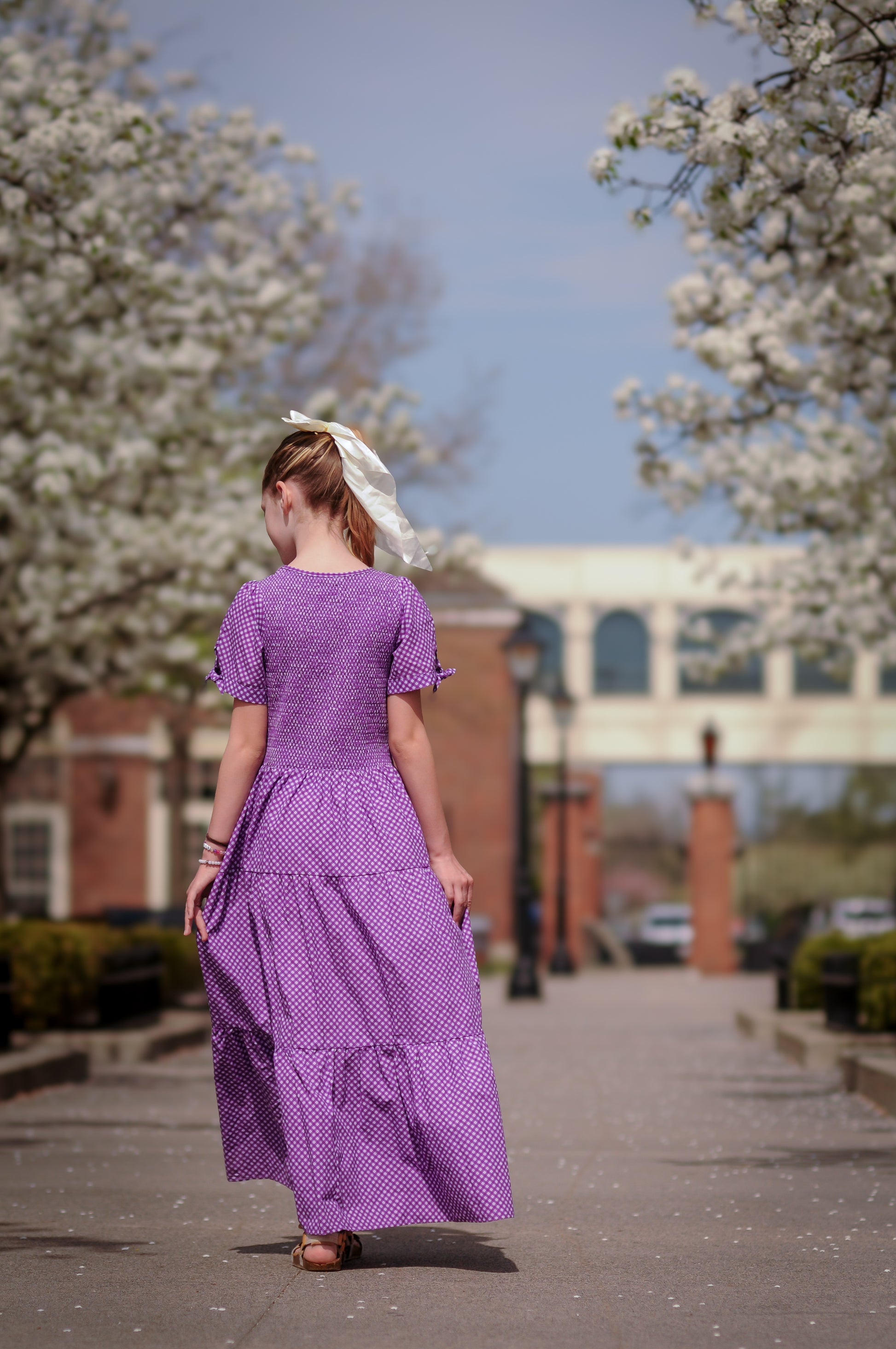 Young girl wearing a modest purple dress