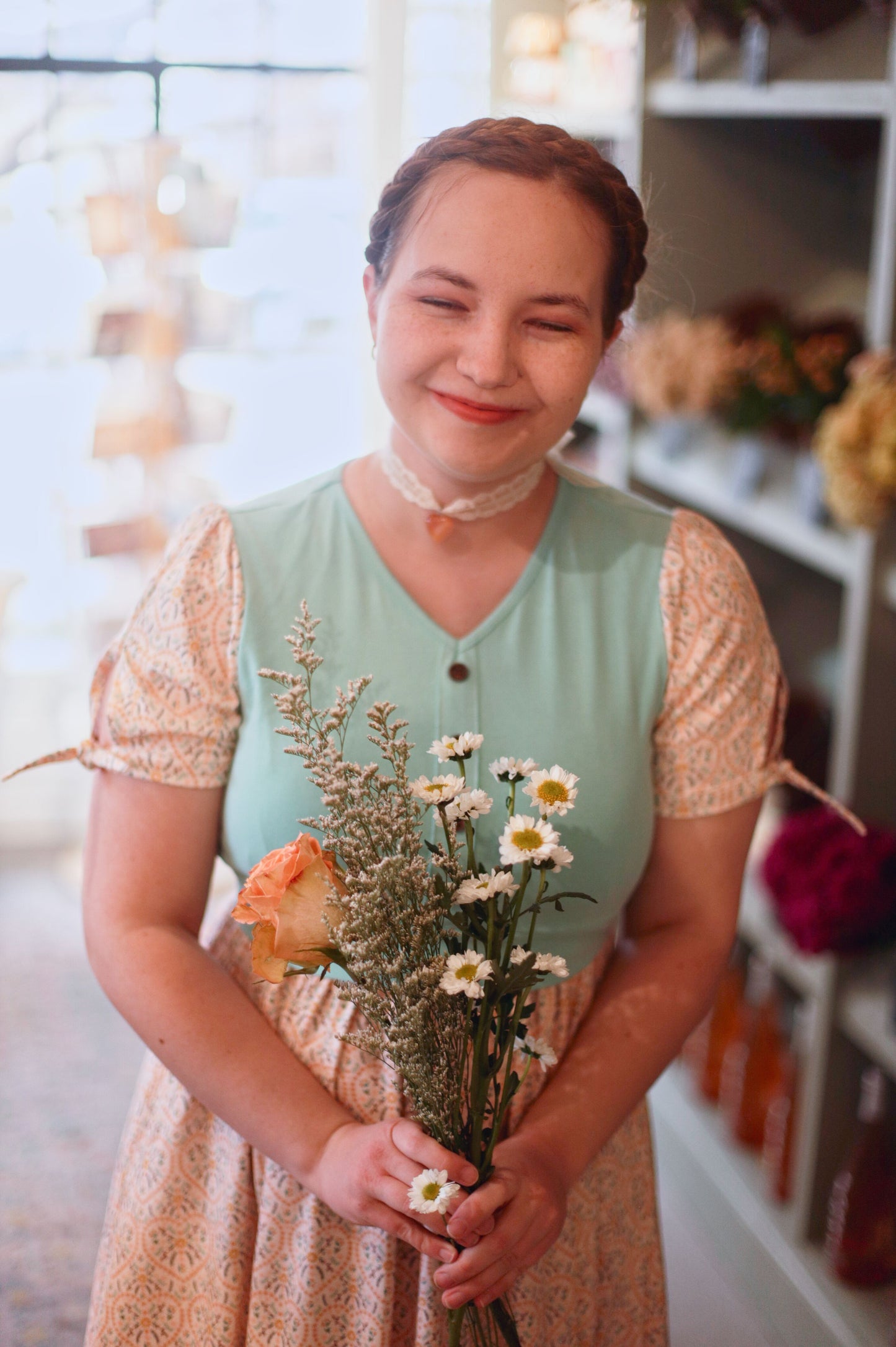 A woman wearing a vintage style modest nursing dress.