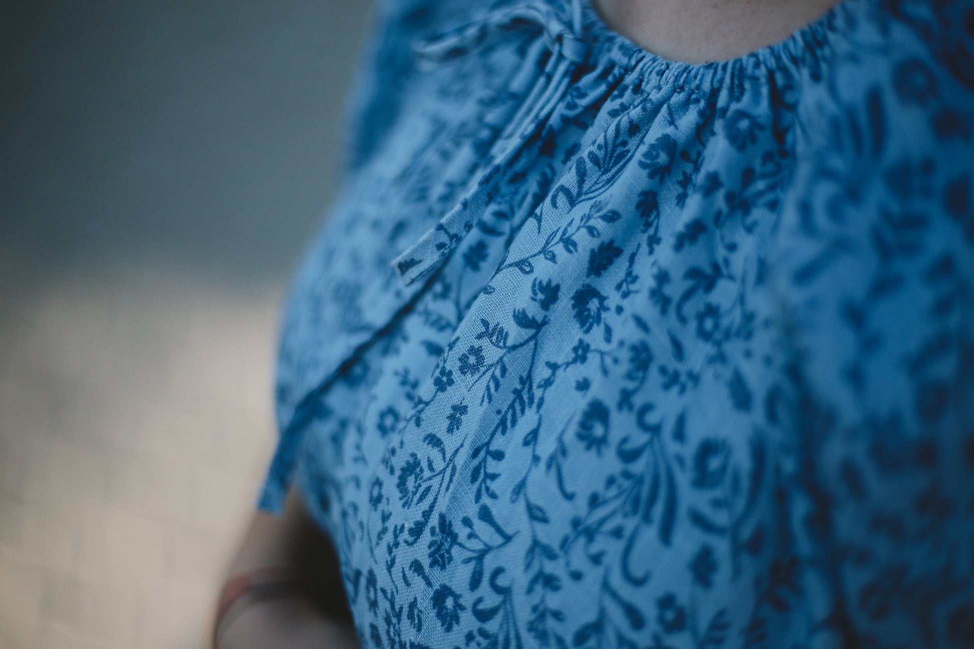 Close-up of a blue patterned modest nursing dress with a blurred background