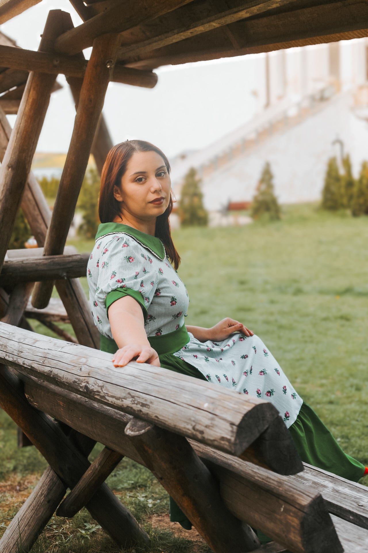 woman wearing a green and white striped modest nursing dress
