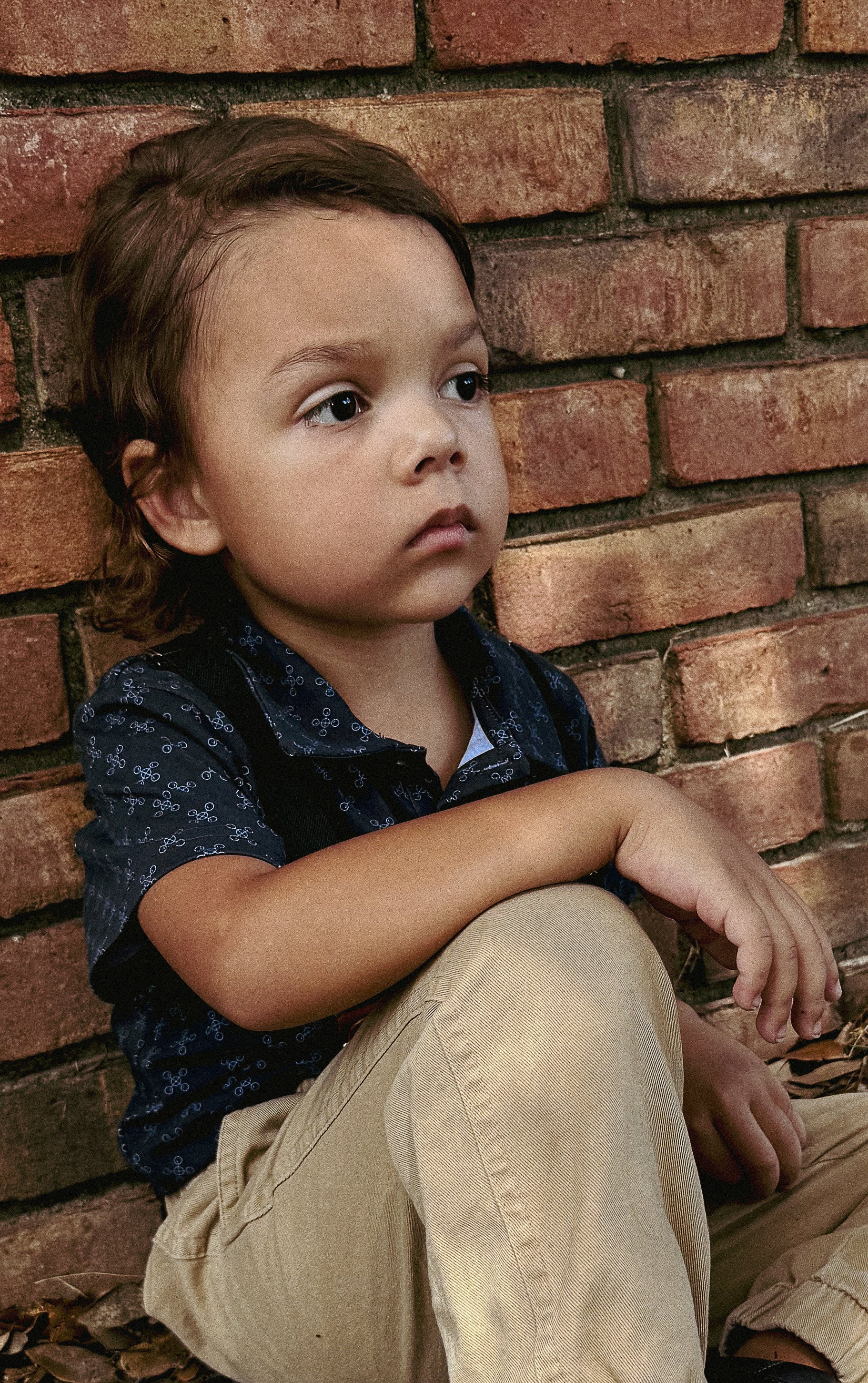 Young boy wearing a dark blue polo shirt