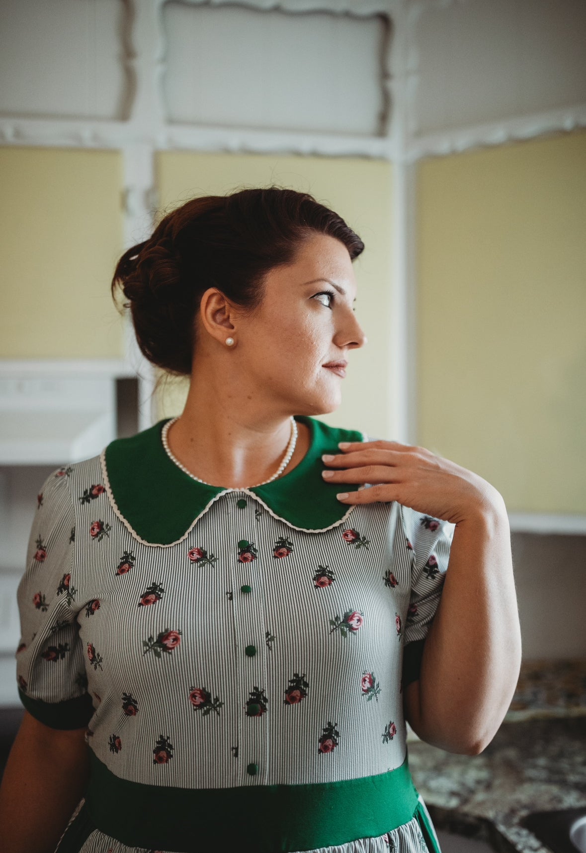 woman wearing a green and white striped modest nursing dress