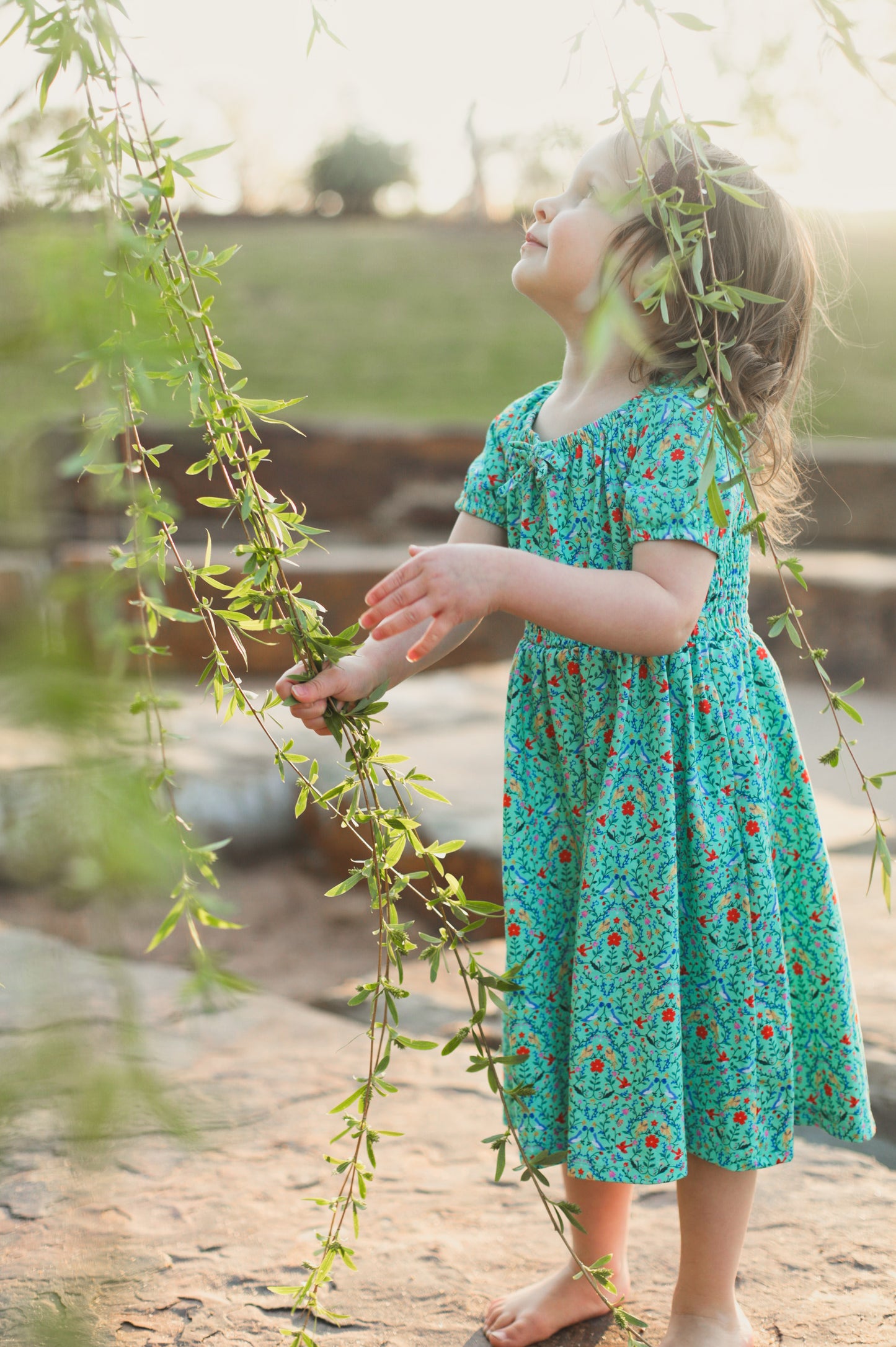 Young girl wearing a modest green dress