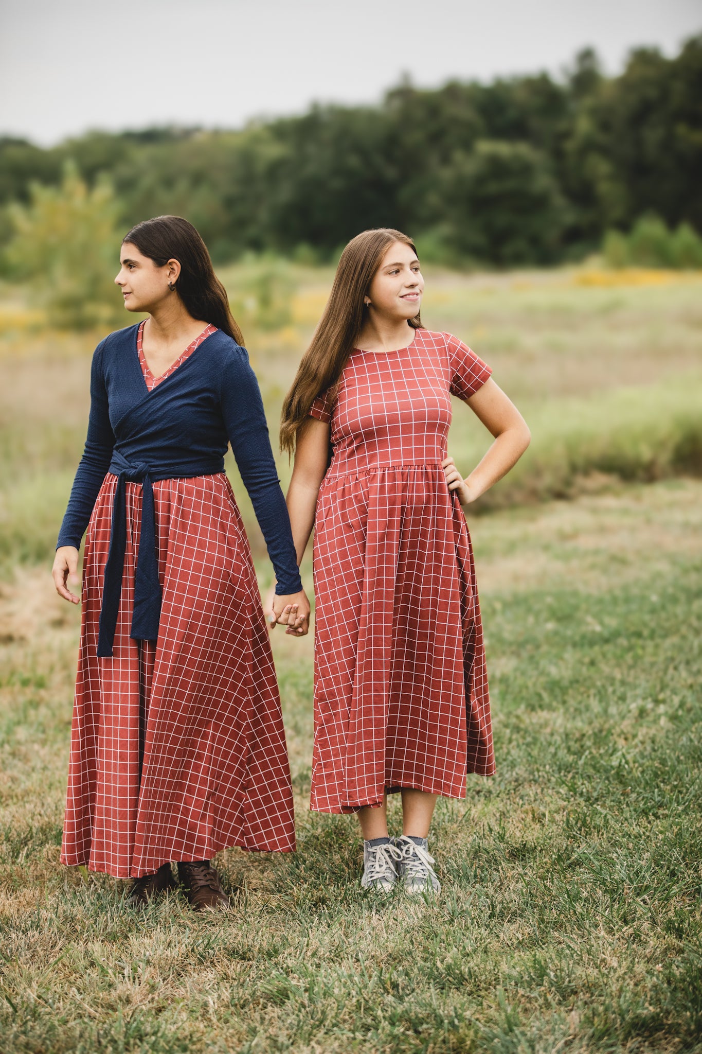 Women in modest checkered dresses, nursing-friendly design.