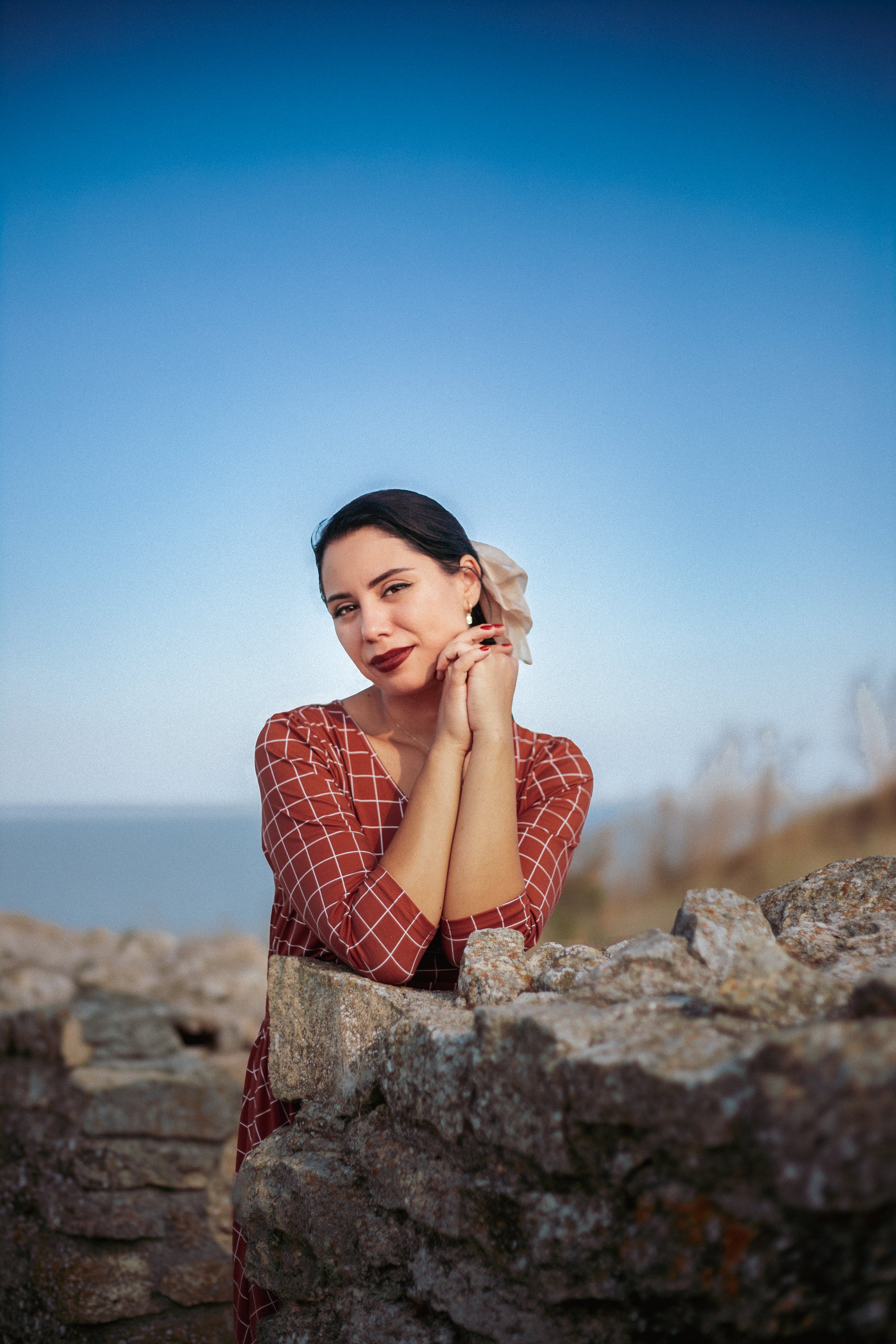 Woman in modest nursing copper dress outdoors
